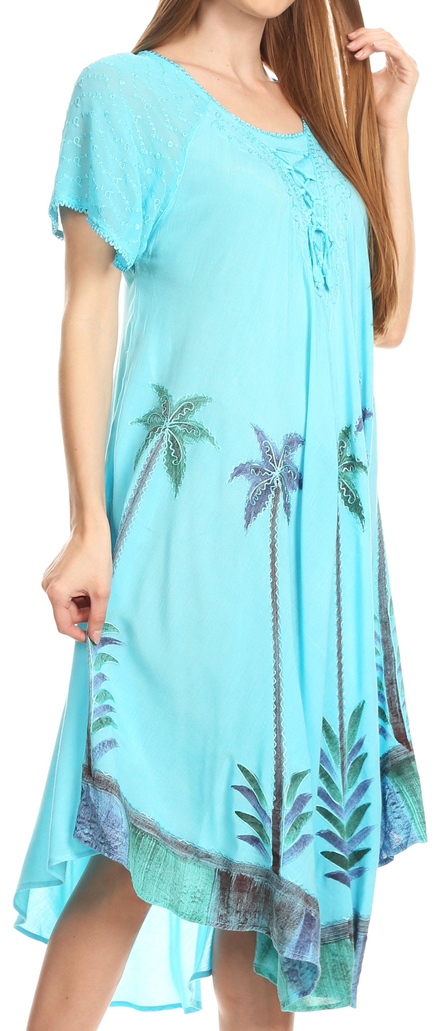 Light blue dress with palm tree patterns worn by a model