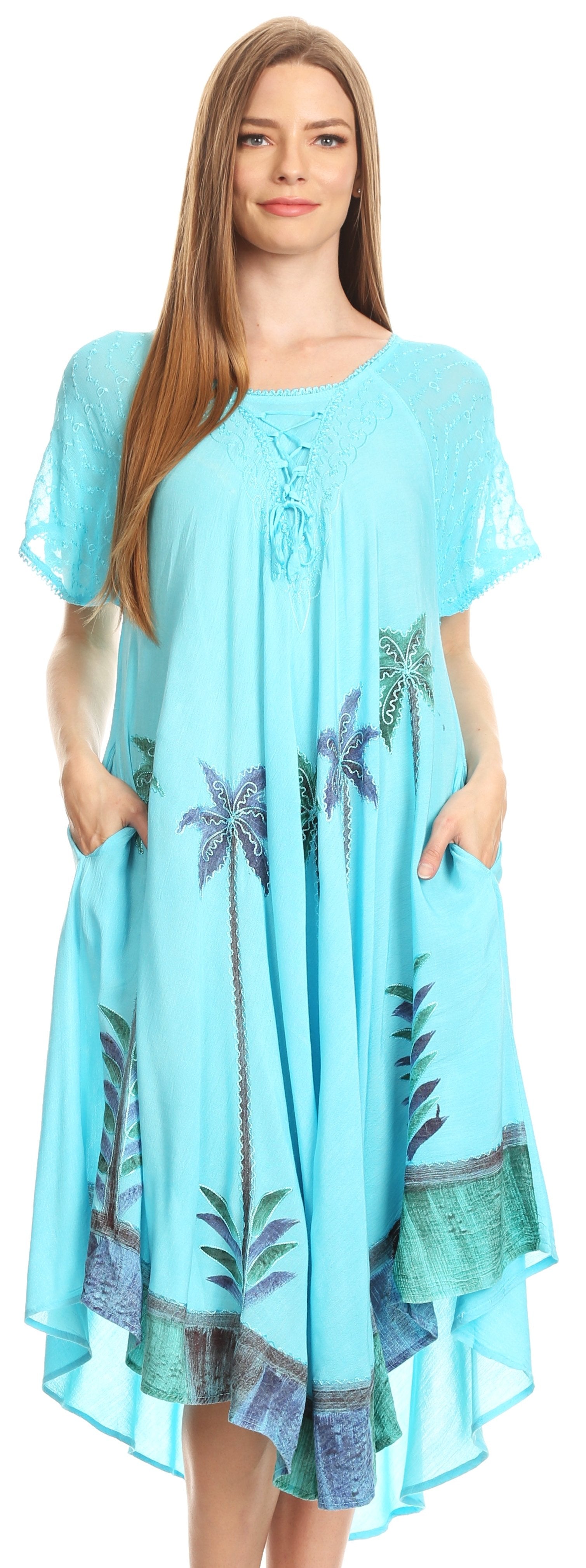 Woman wearing a light blue dress with palm tree patterns on a white background