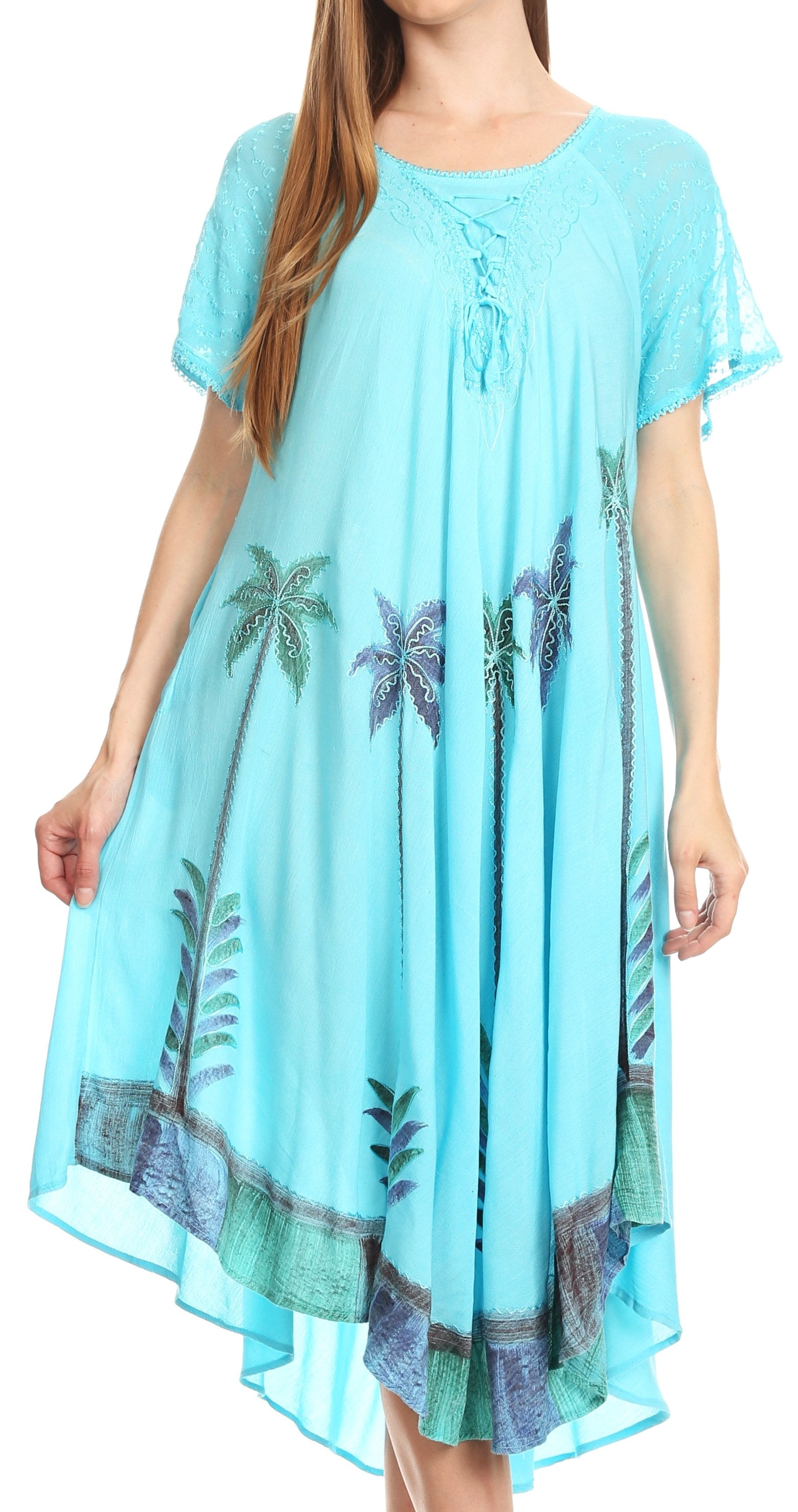 Woman wearing a turquoise dress with palm tree patterns on a white background