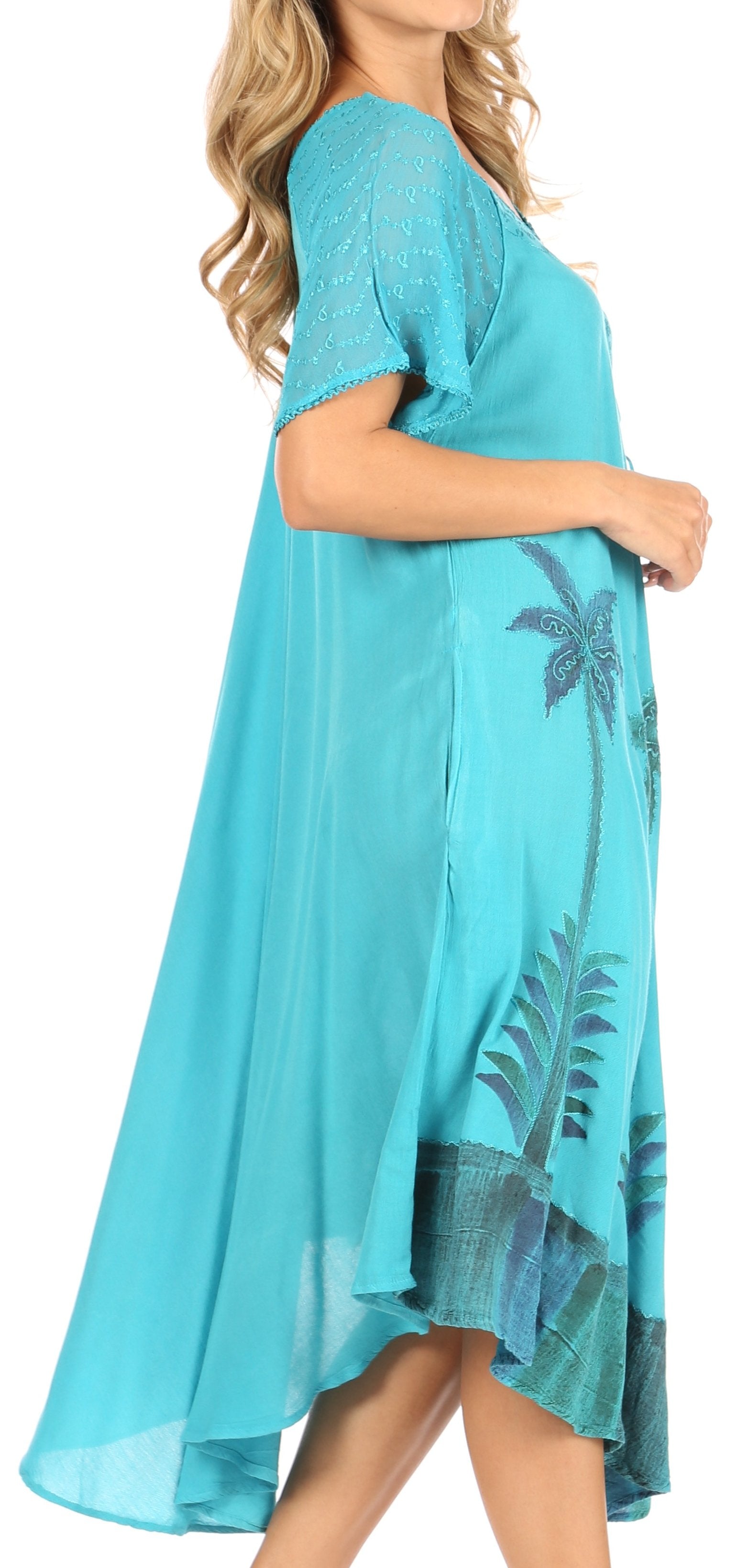 Turquoise dress with palm tree design on a white background