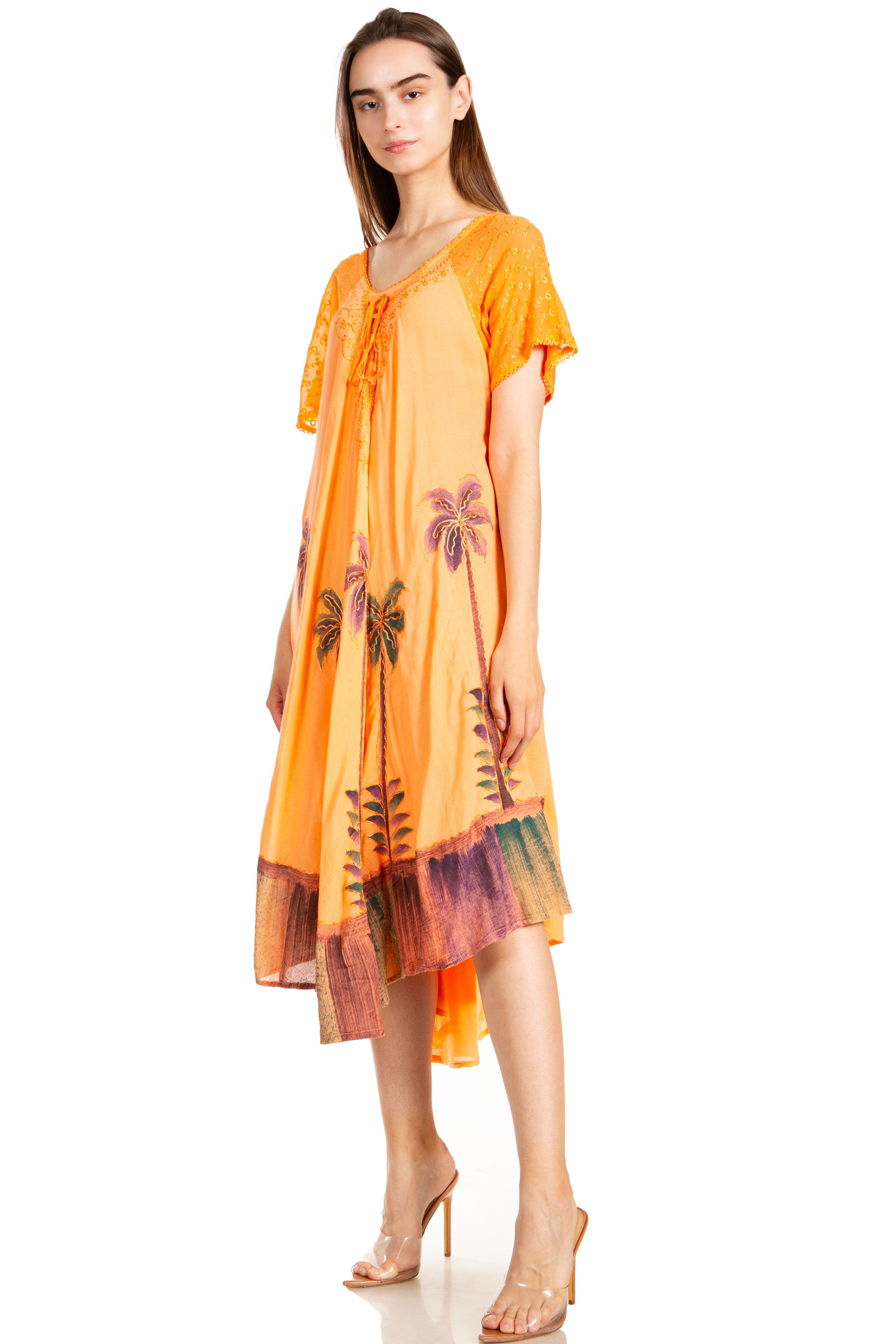 Woman wearing an orange dress with palm tree patterns on a white background