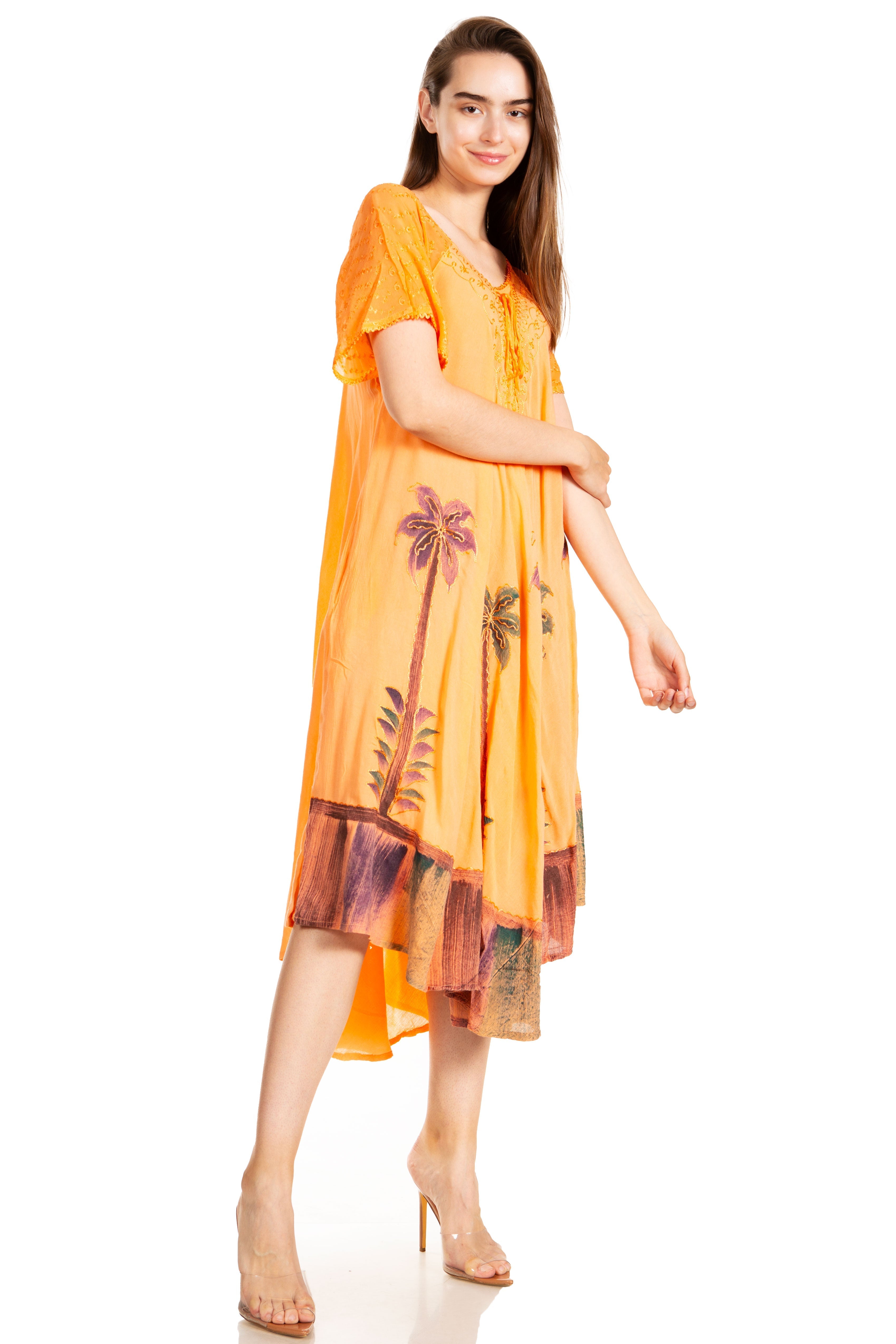 Woman wearing an orange dress with palm tree design on a white background