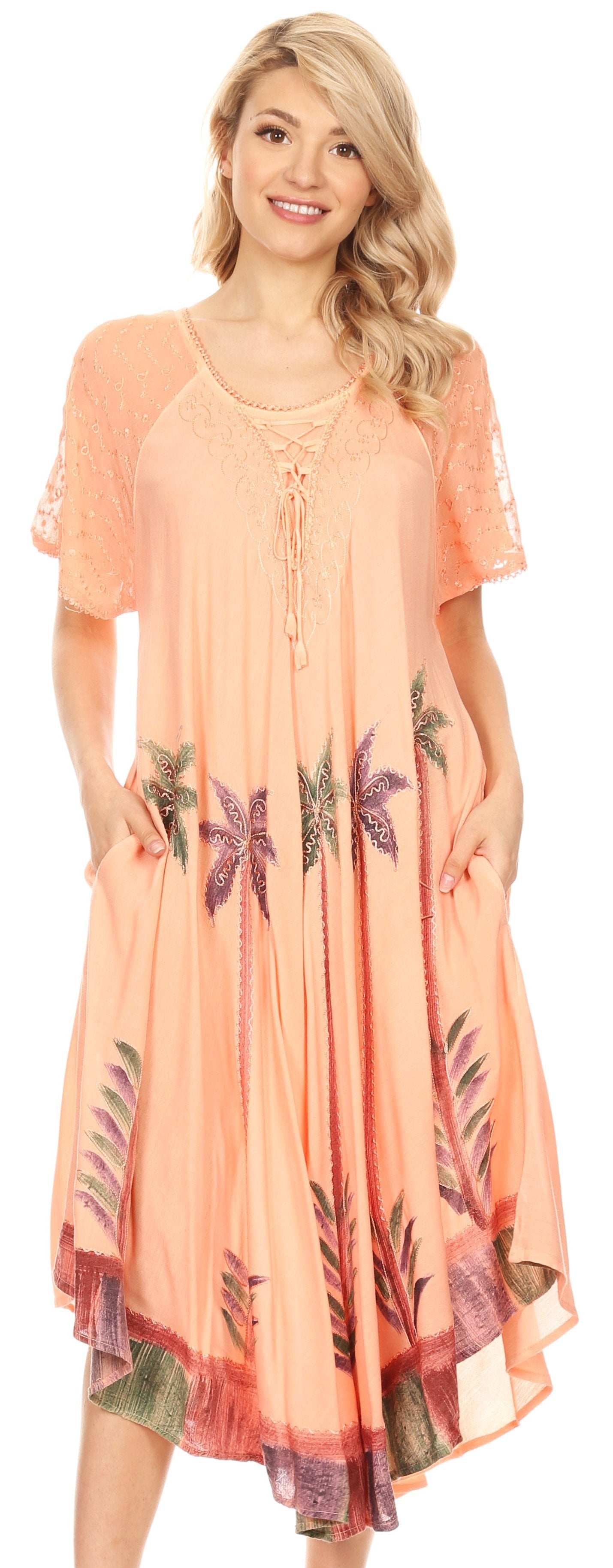 Woman wearing a peach-colored dress with floral patterns on a white background