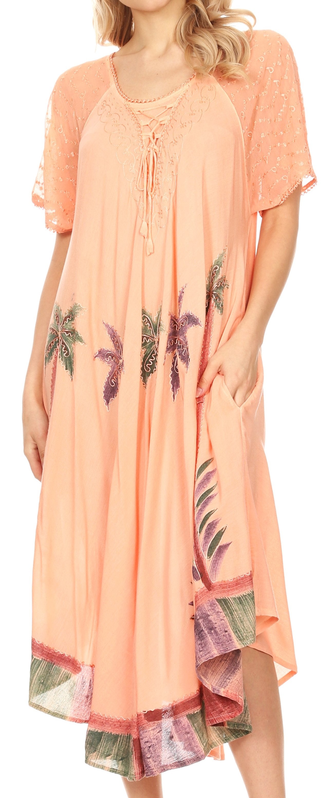 Woman wearing a peach-colored dress with palm tree patterns on a white background