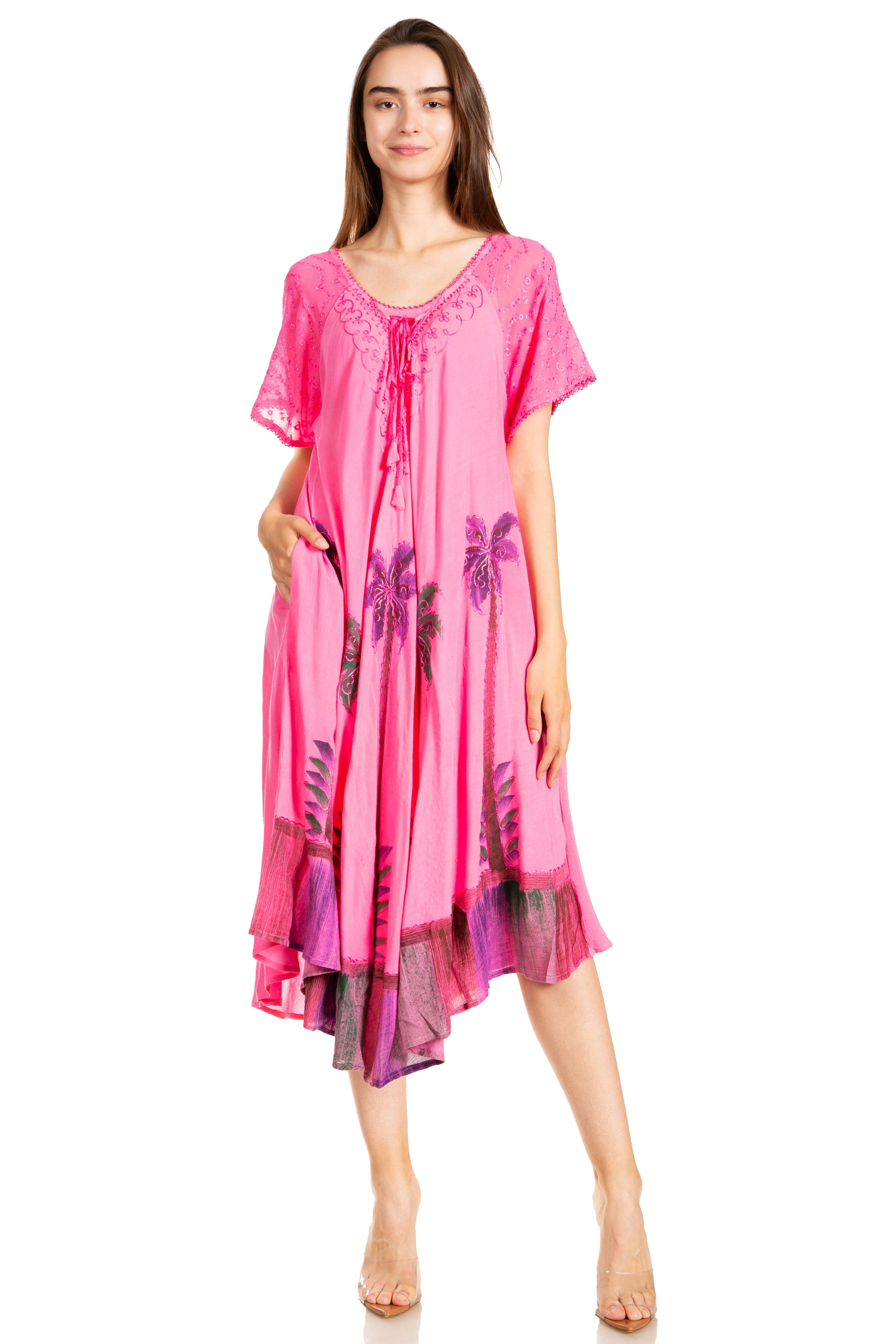 Woman wearing a pink dress with floral patterns on a white background