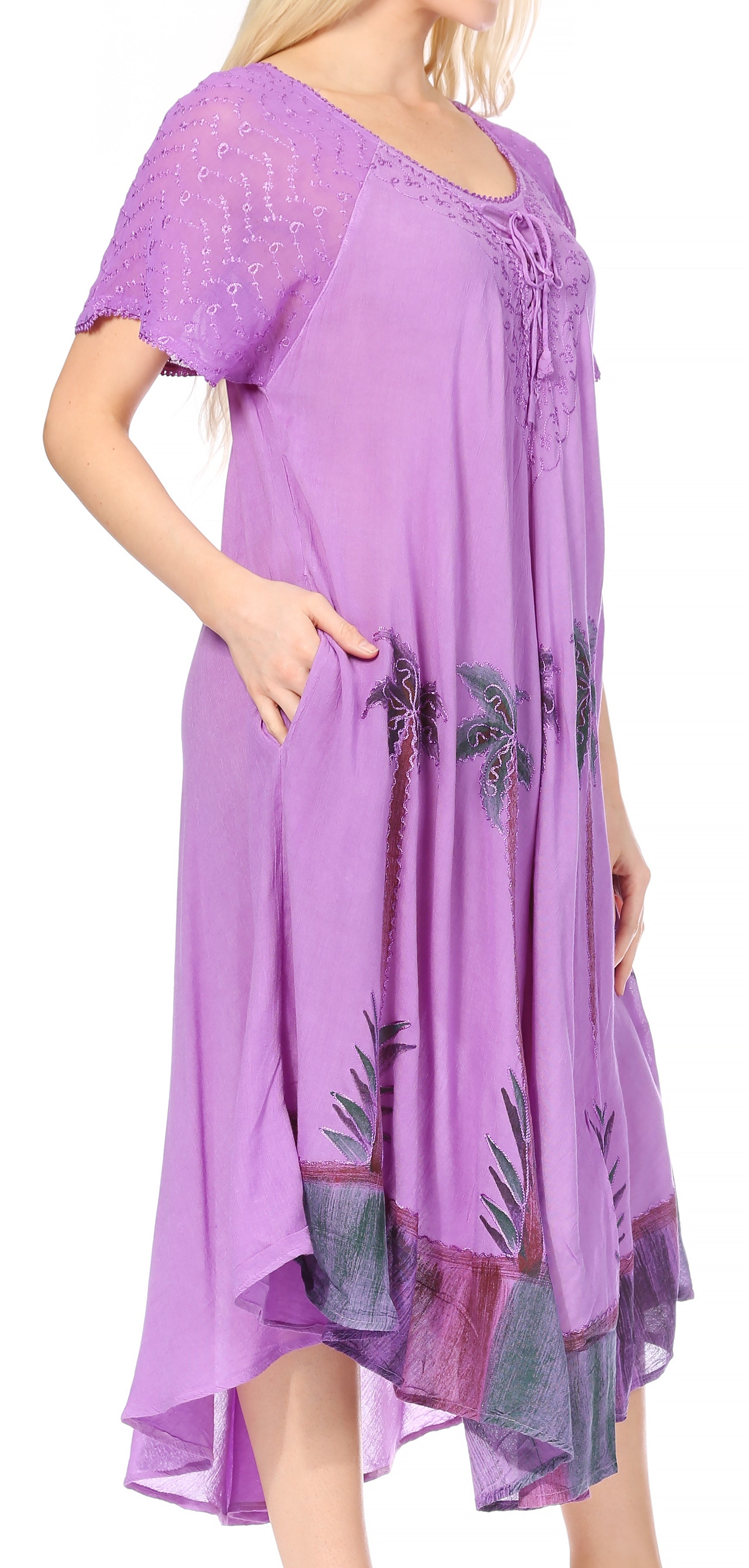 Purple dress with palm tree design worn by a model on a white background