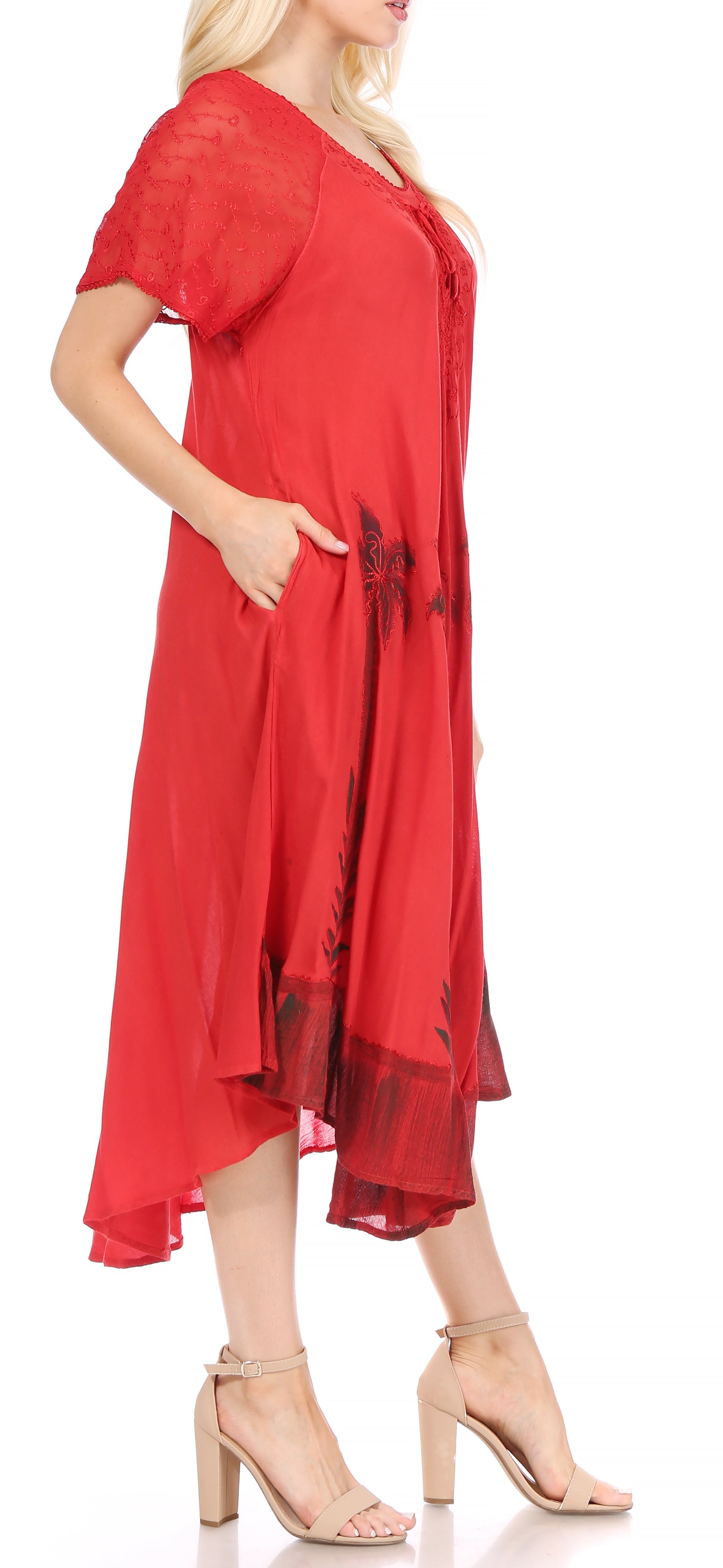 Woman wearing a red dress with a floral pattern on a white background