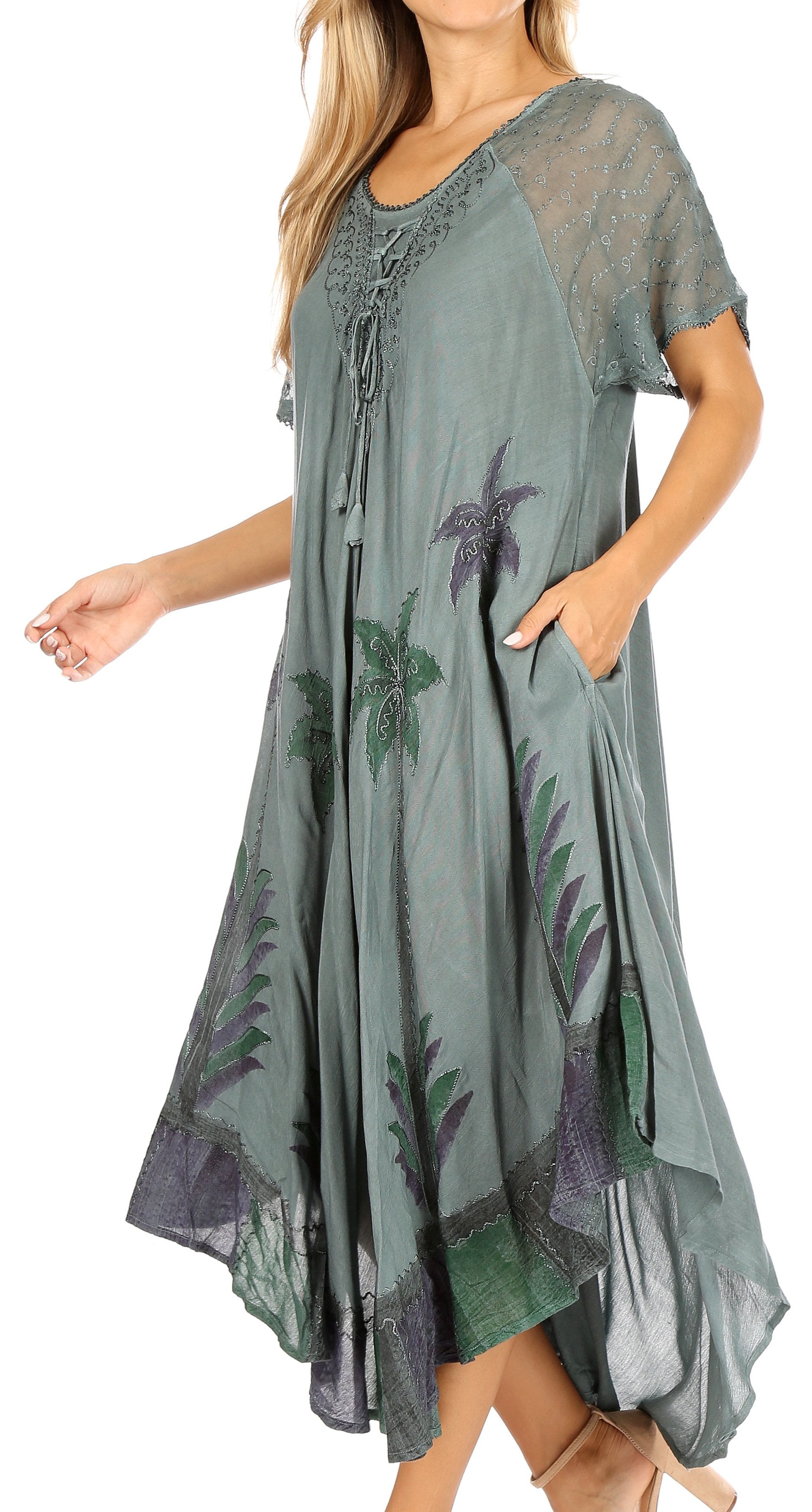 Woman wearing a green dress with floral patterns on a white background