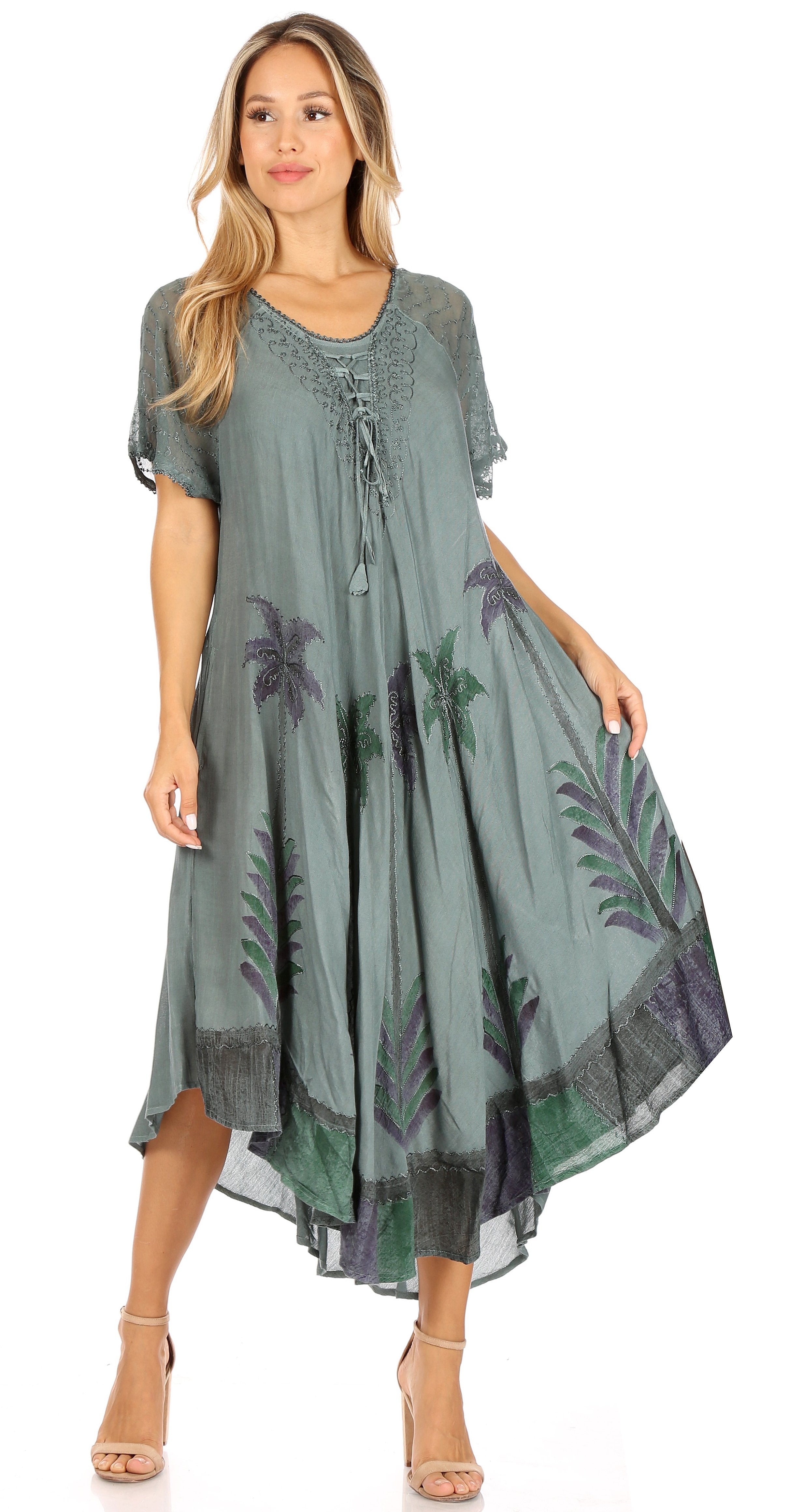 Woman wearing a green dress with floral patterns on a white background