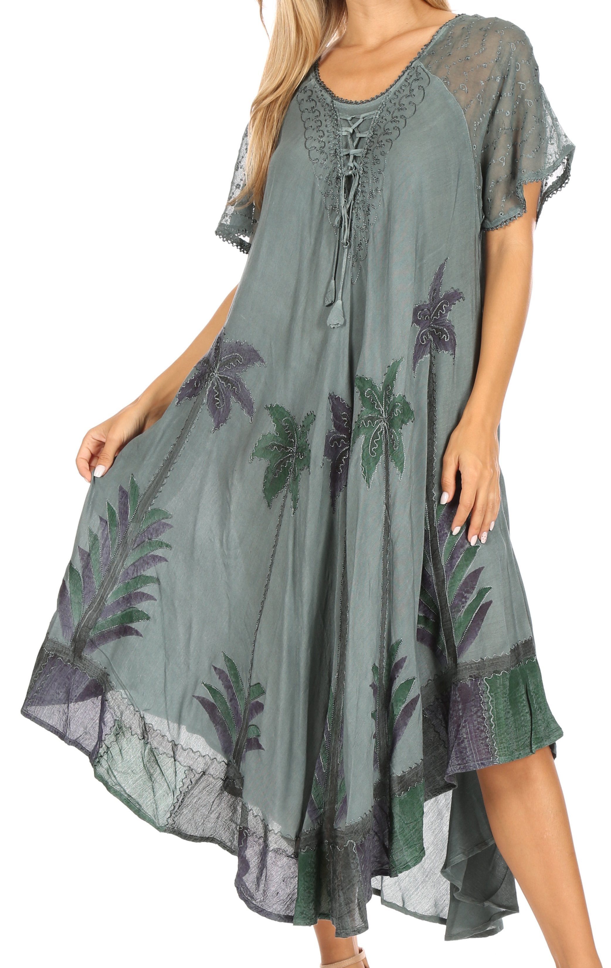Woman wearing a green dress with floral patterns on a white background