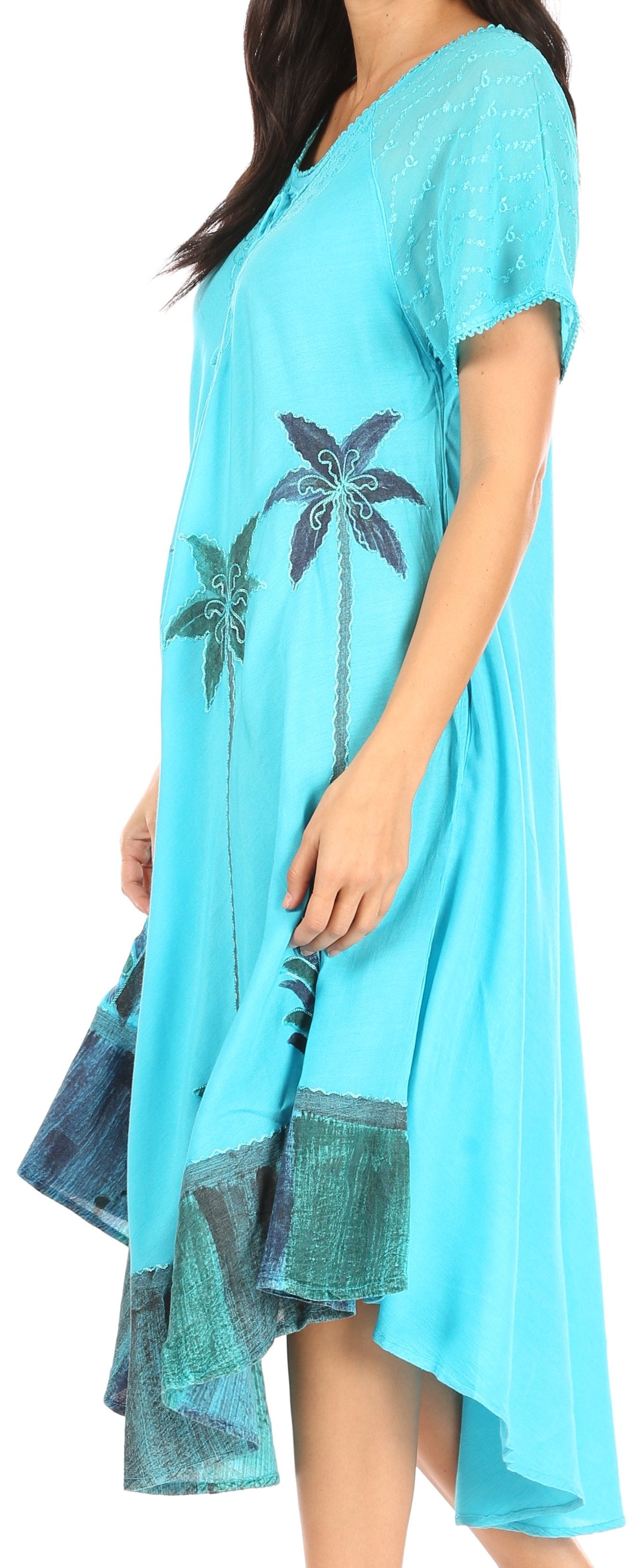Woman wearing a turquoise dress with palm tree design on a white background