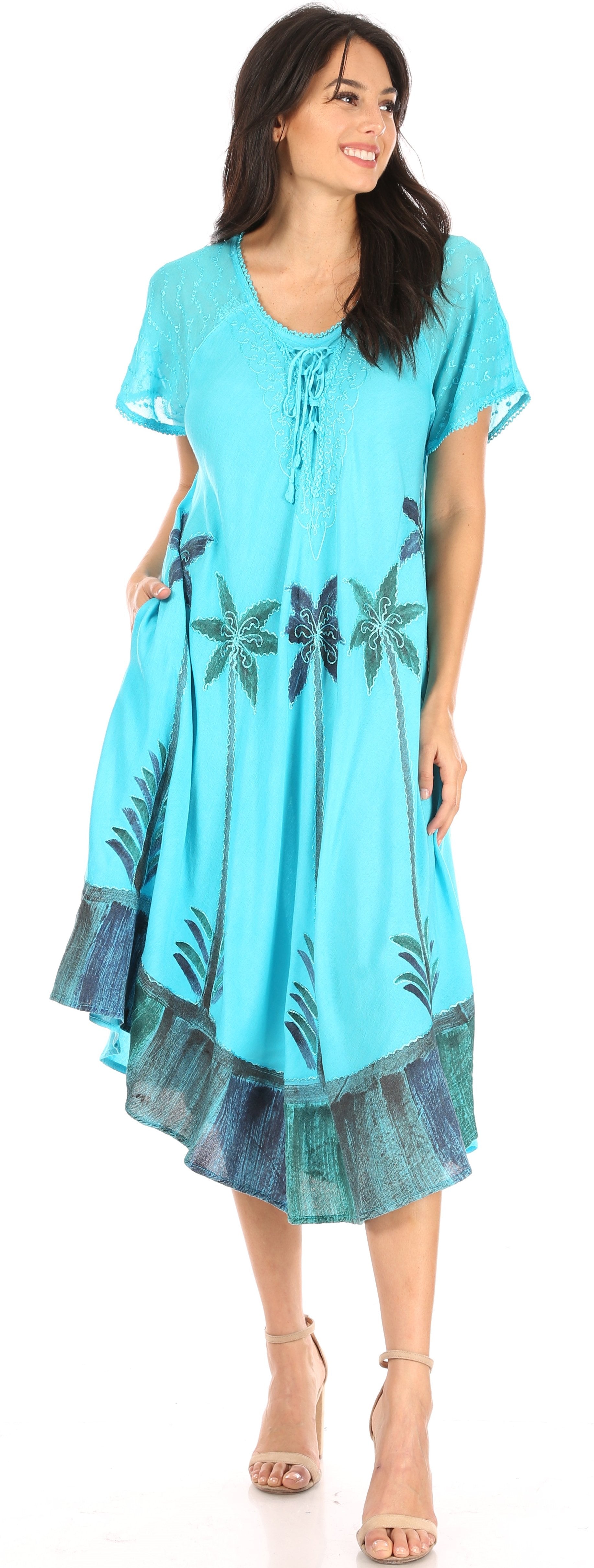 Woman wearing a blue dress with floral patterns on a white background