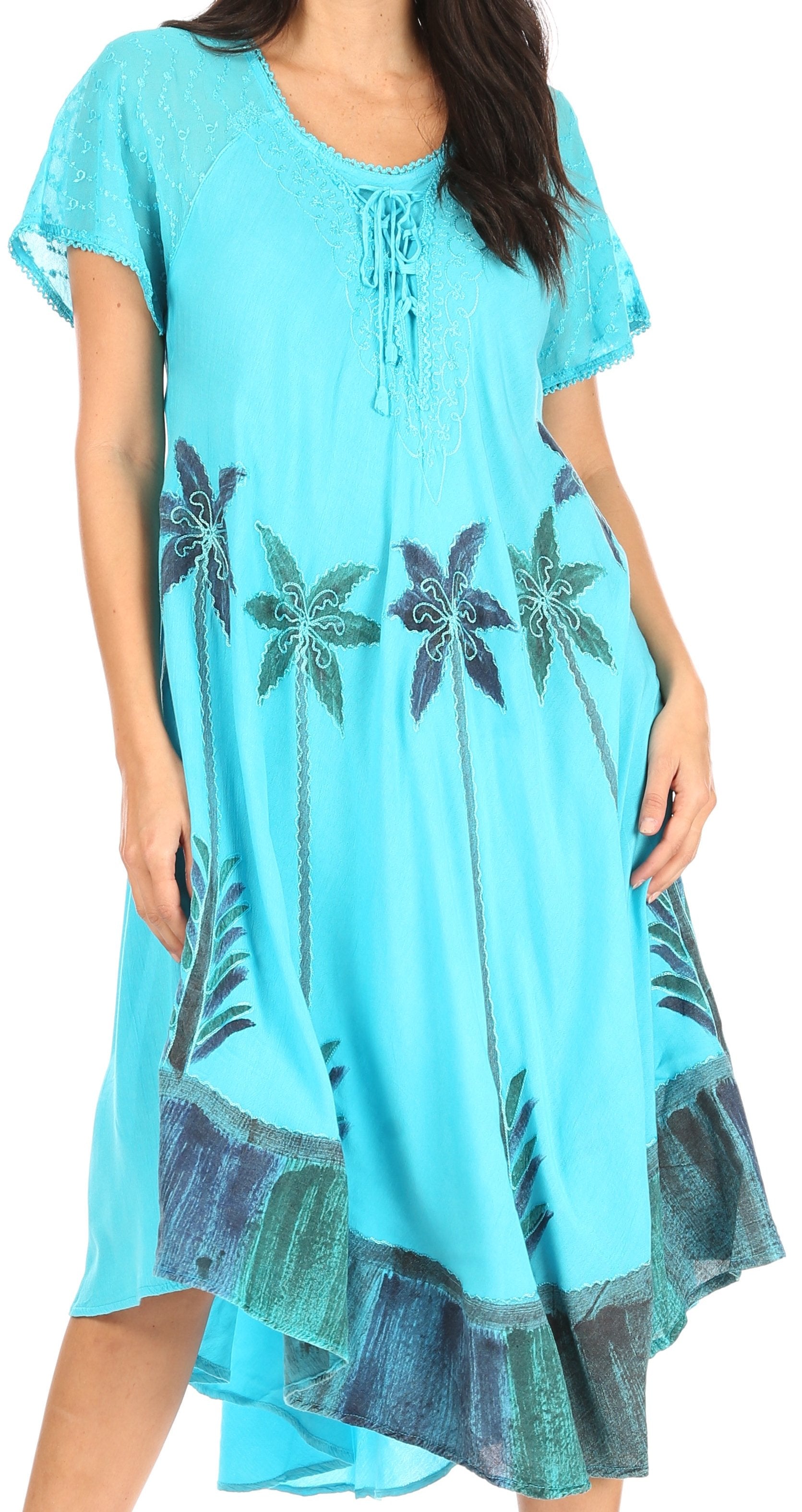 Woman wearing a turquoise dress with palm tree patterns on a white background