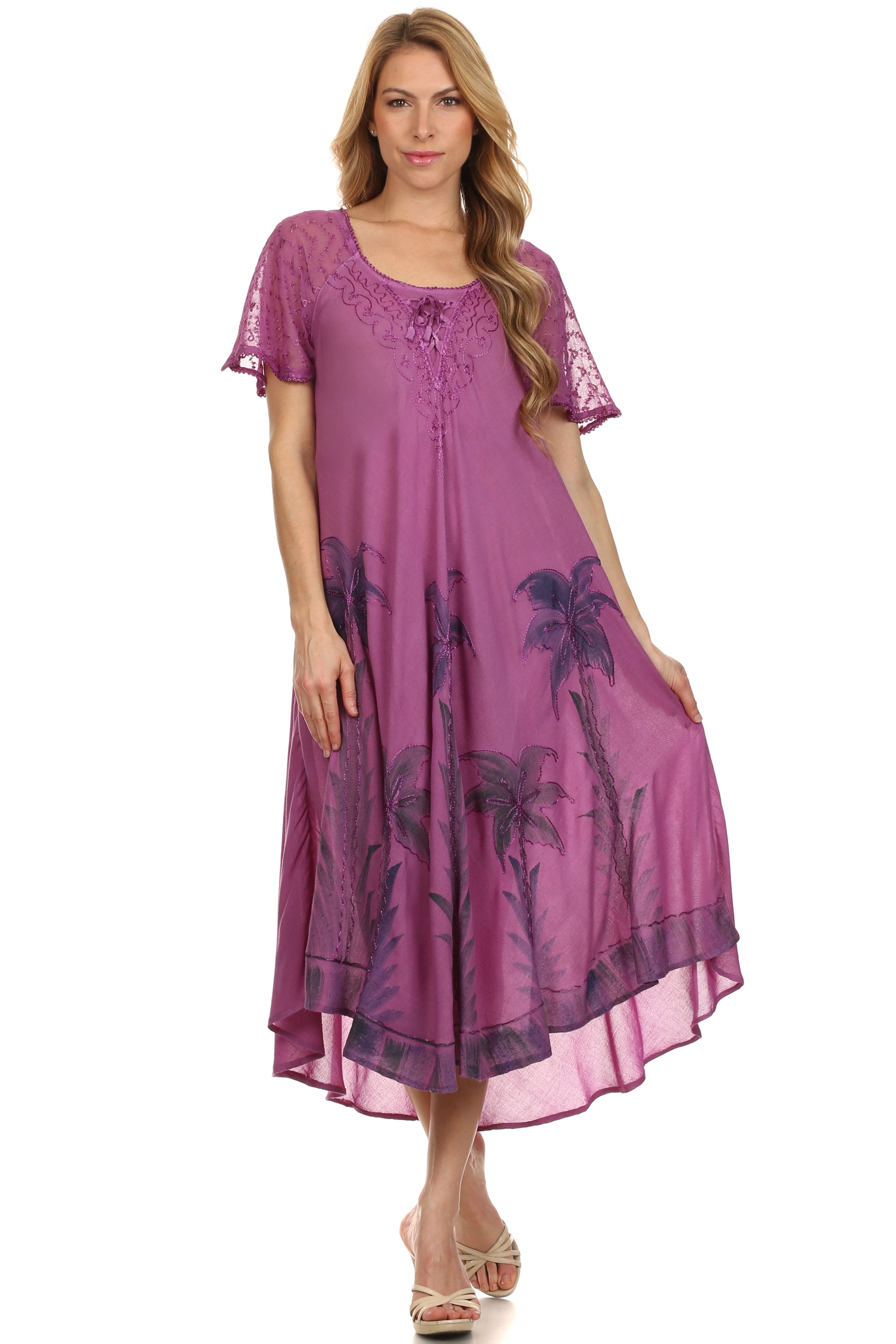 Woman wearing a purple dress with palm tree pattern on a white background