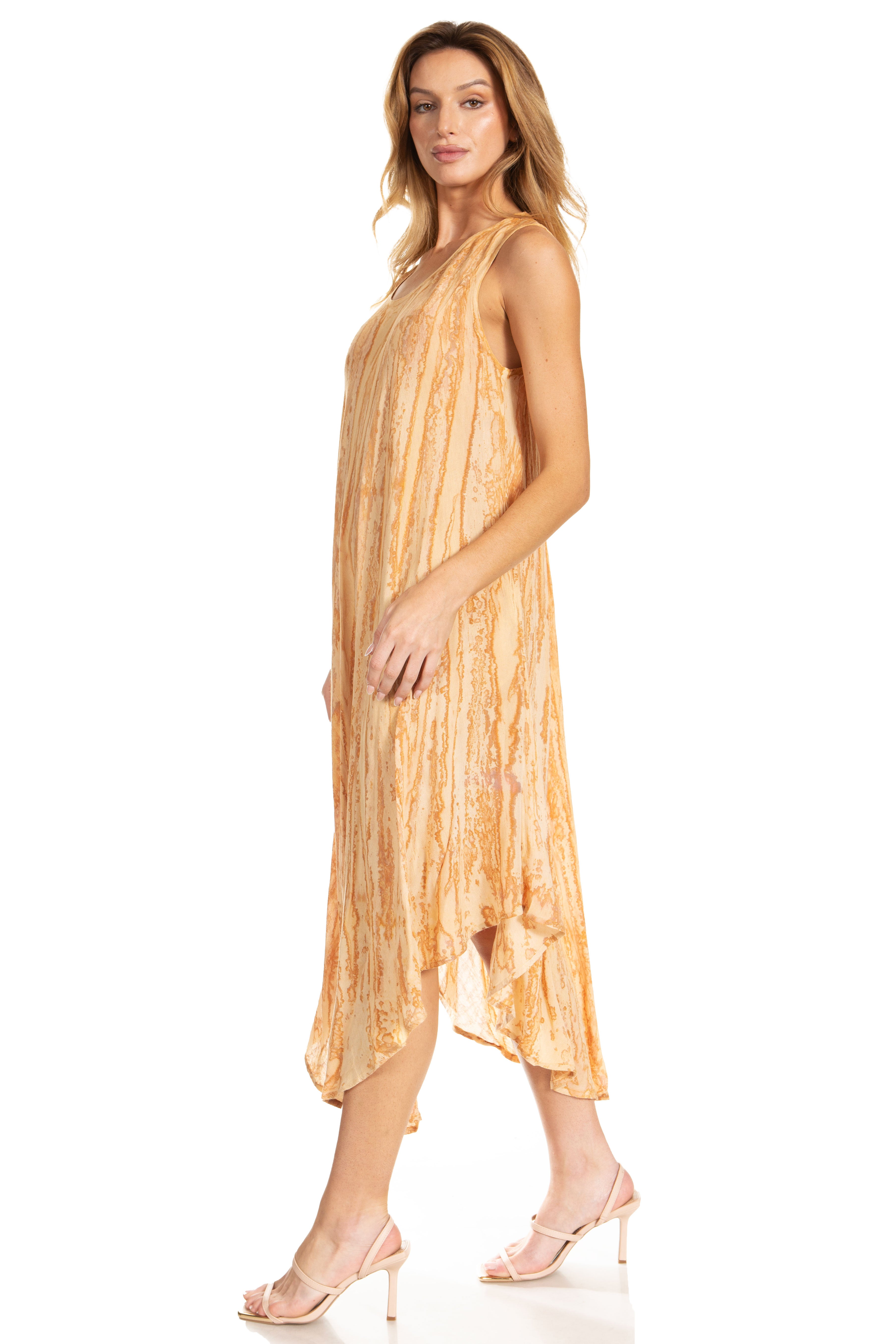 Woman wearing a yellow patterned dress on a white background
