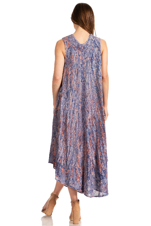 Woman wearing a sleeveless, patterned dress on a white background