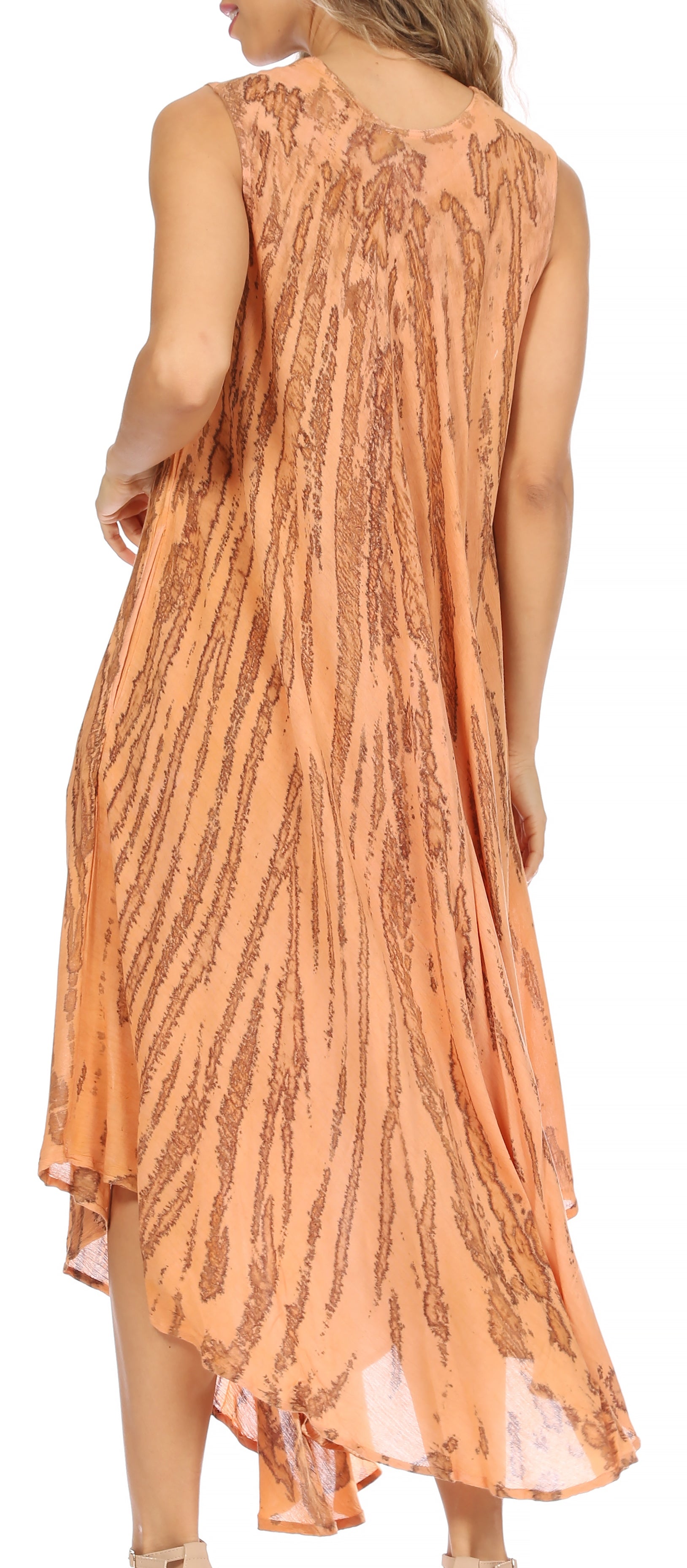 Woman wearing a peach-colored dress with a subtle pattern on a white background