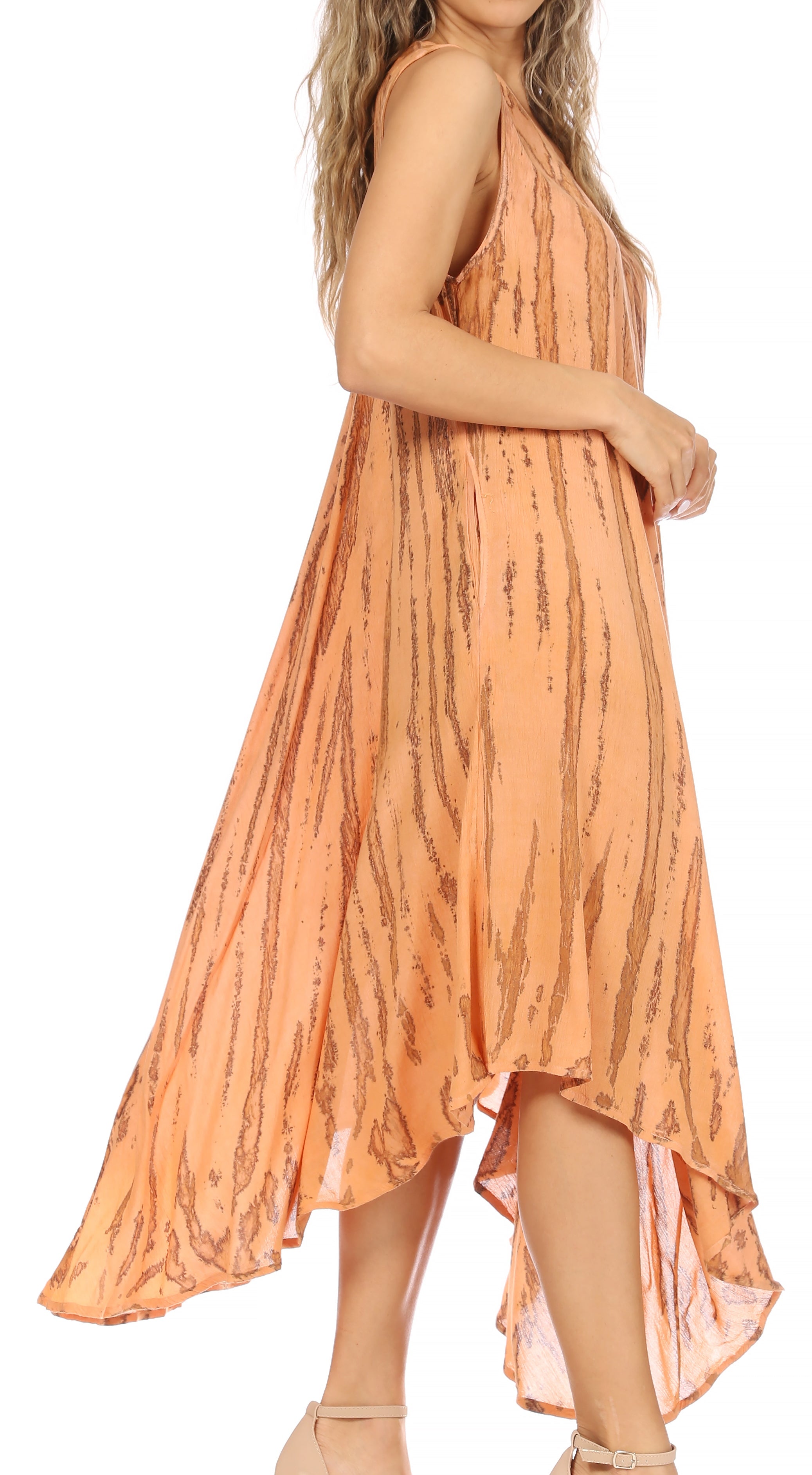 Woman wearing a peach-colored dress with a subtle pattern on a white background