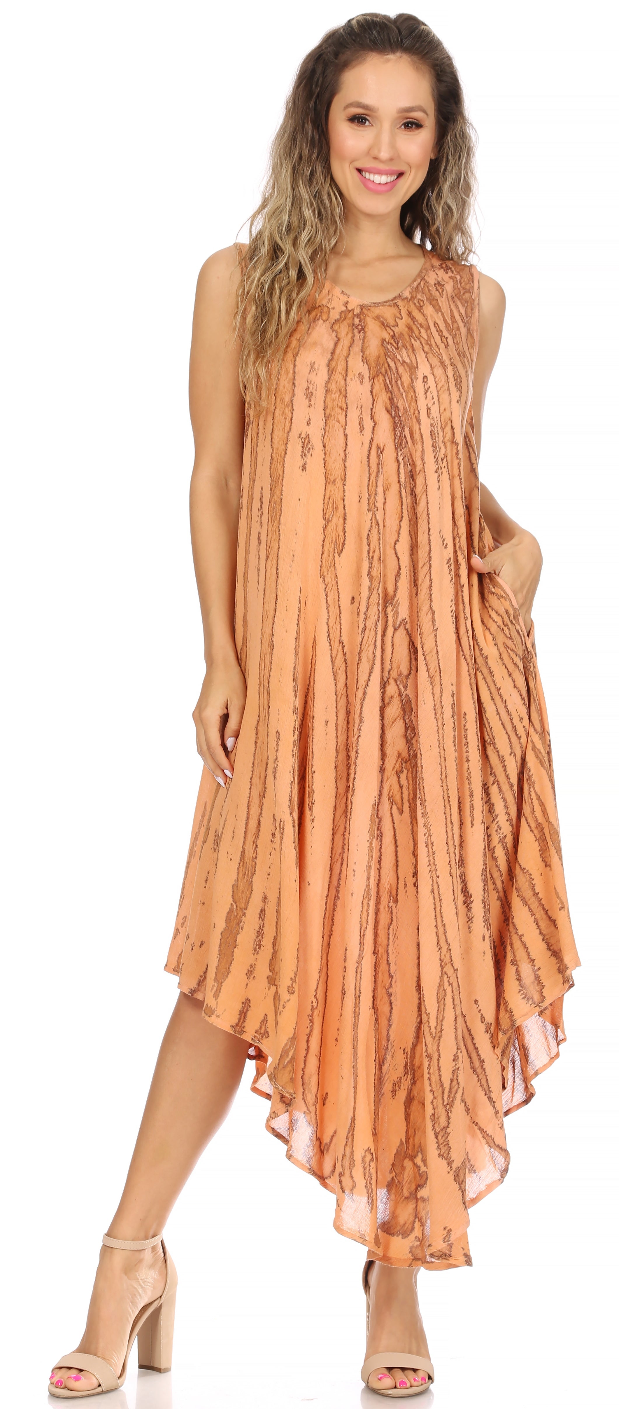 Woman wearing a sleeveless, flowing orange dress on a white background