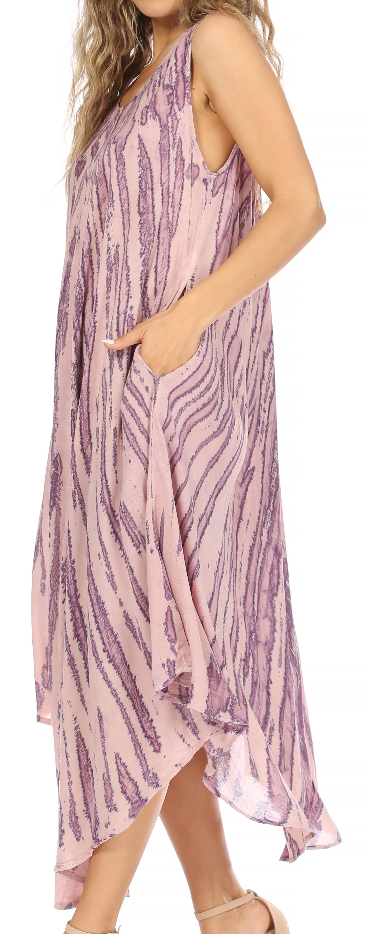 Woman wearing a pink and purple patterned dress with a side view.