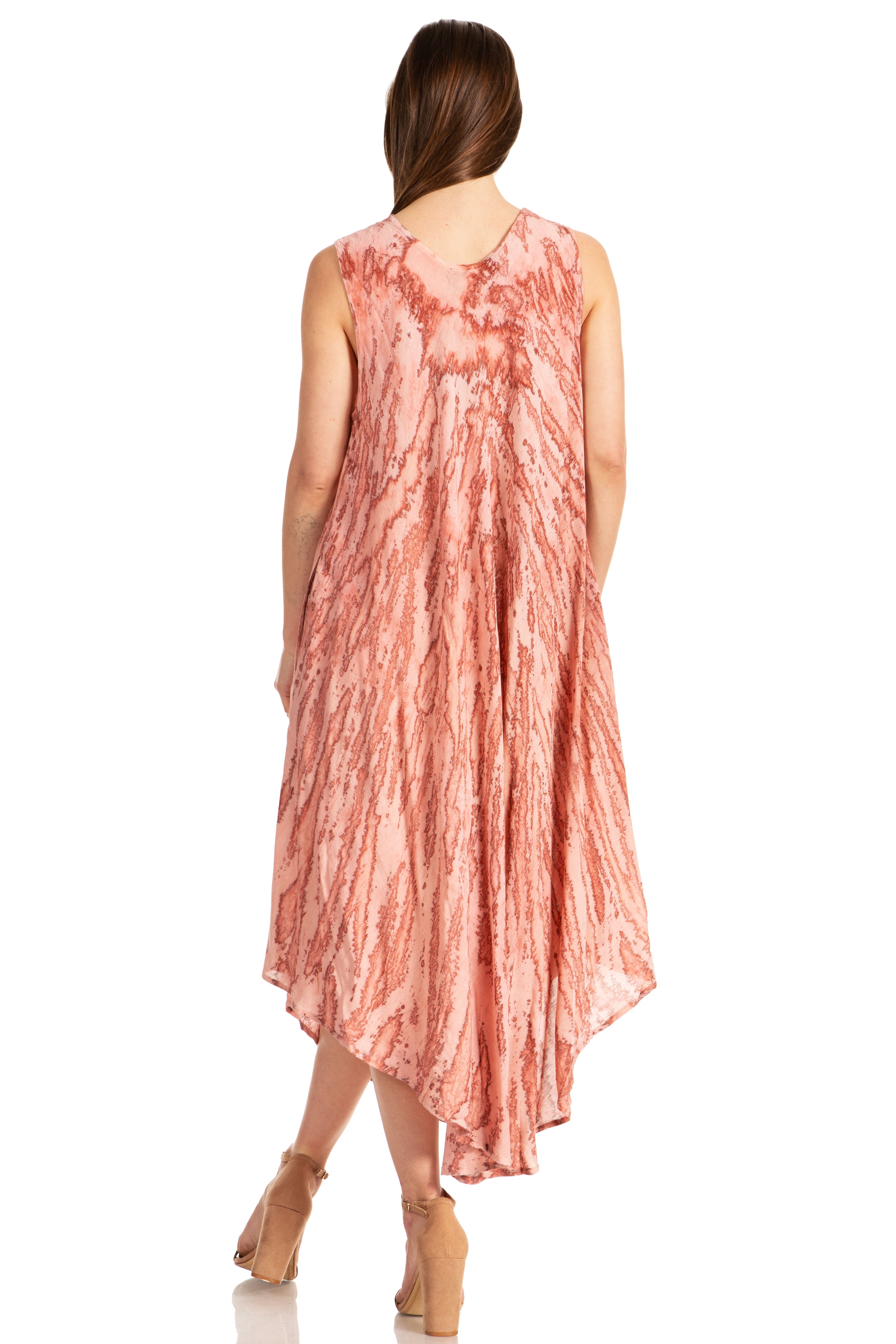 Woman wearing a sleeveless, patterned dress on a white background