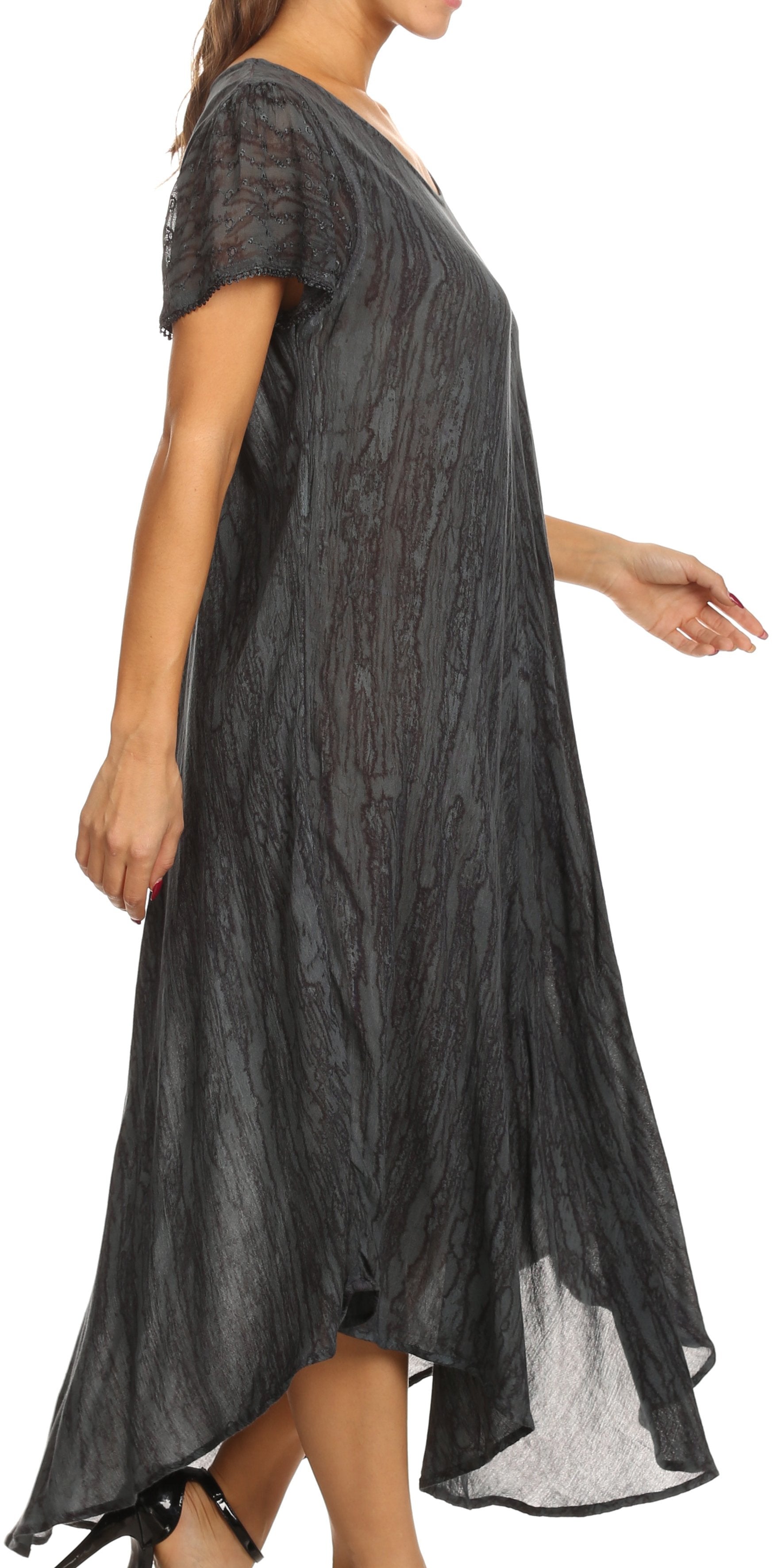Black patterned dress worn by a person on a white background