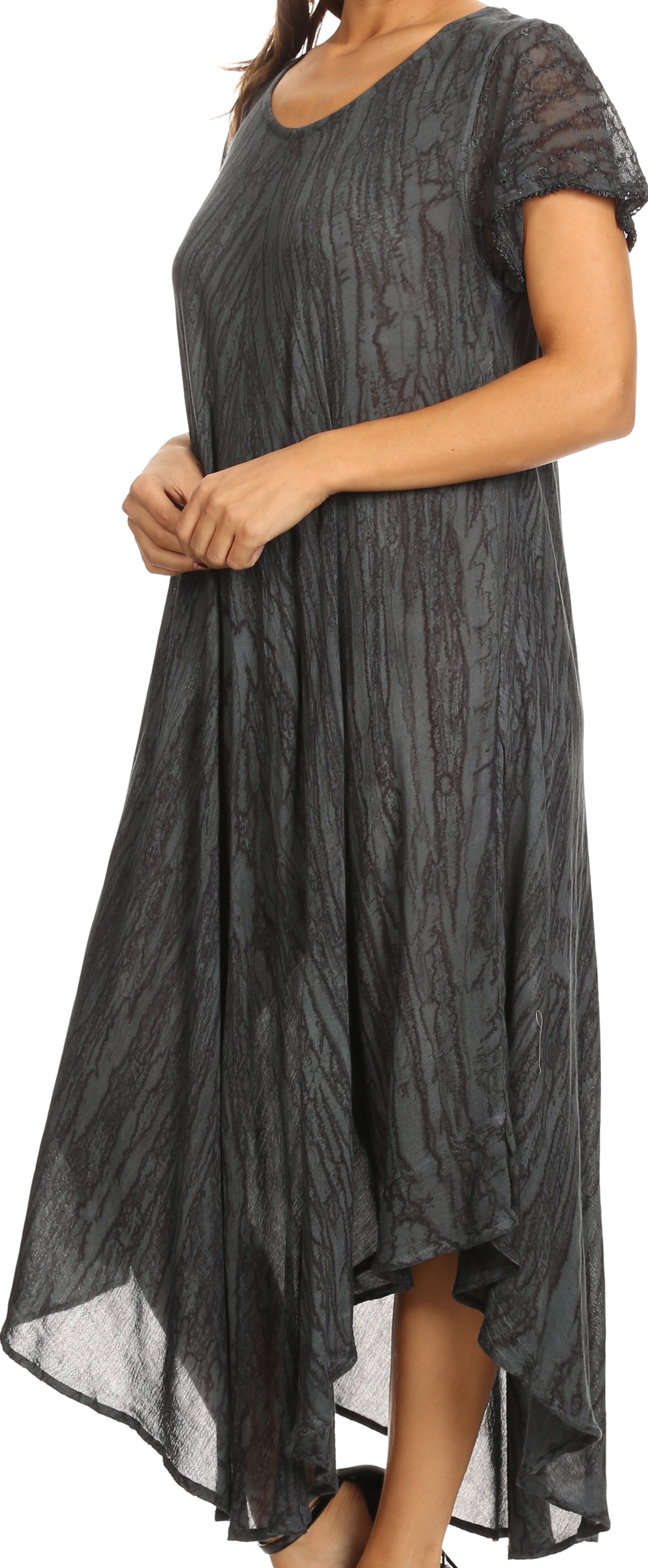 Woman wearing a dark gray patterned dress with short sleeves.
