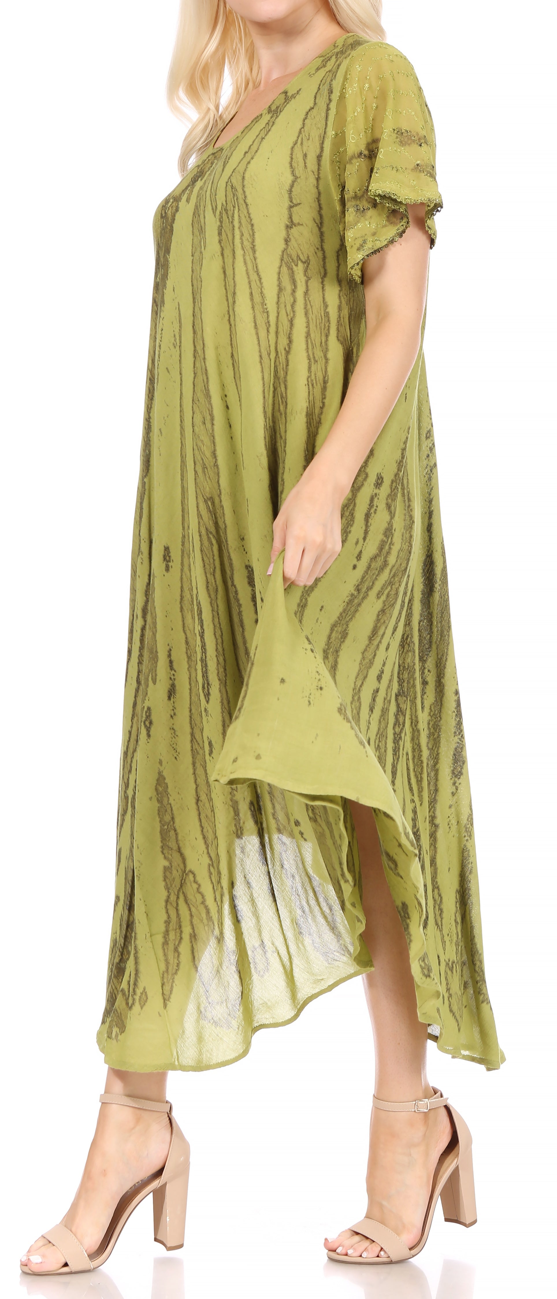 Woman wearing a green dress with a pattern on a white background