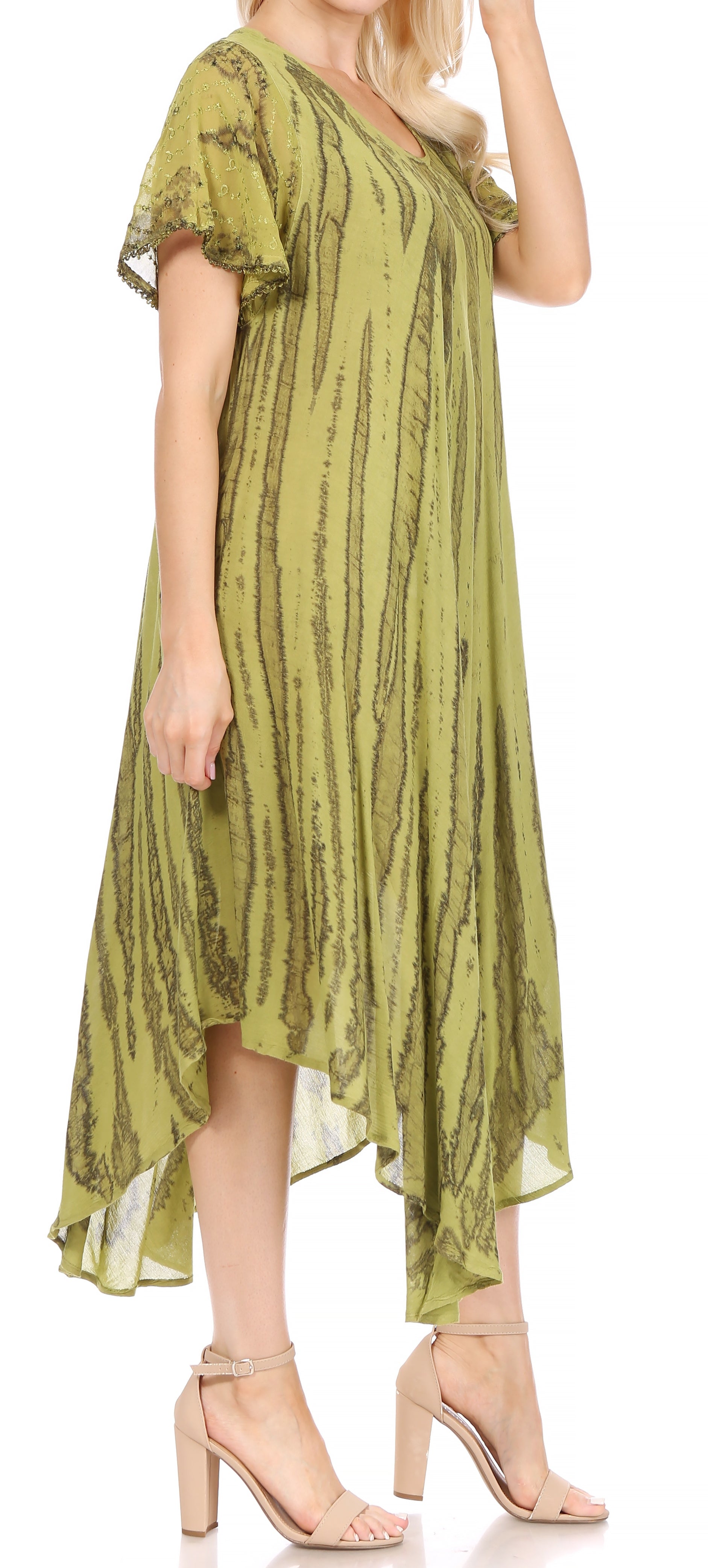 Green patterned dress worn by a model on a white background