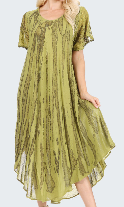 Green patterned dress worn by a model on a white background