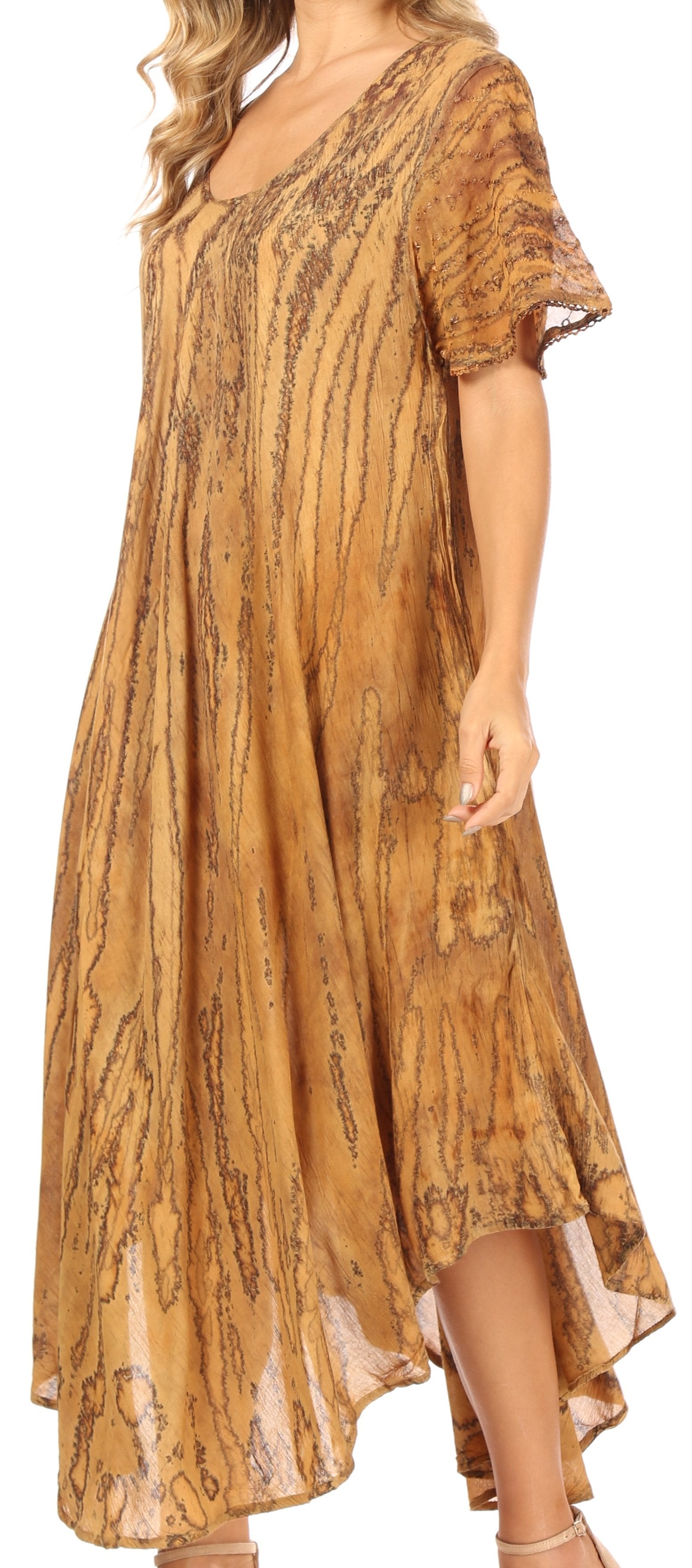 Woman wearing a long, patterned dress with short sleeves.