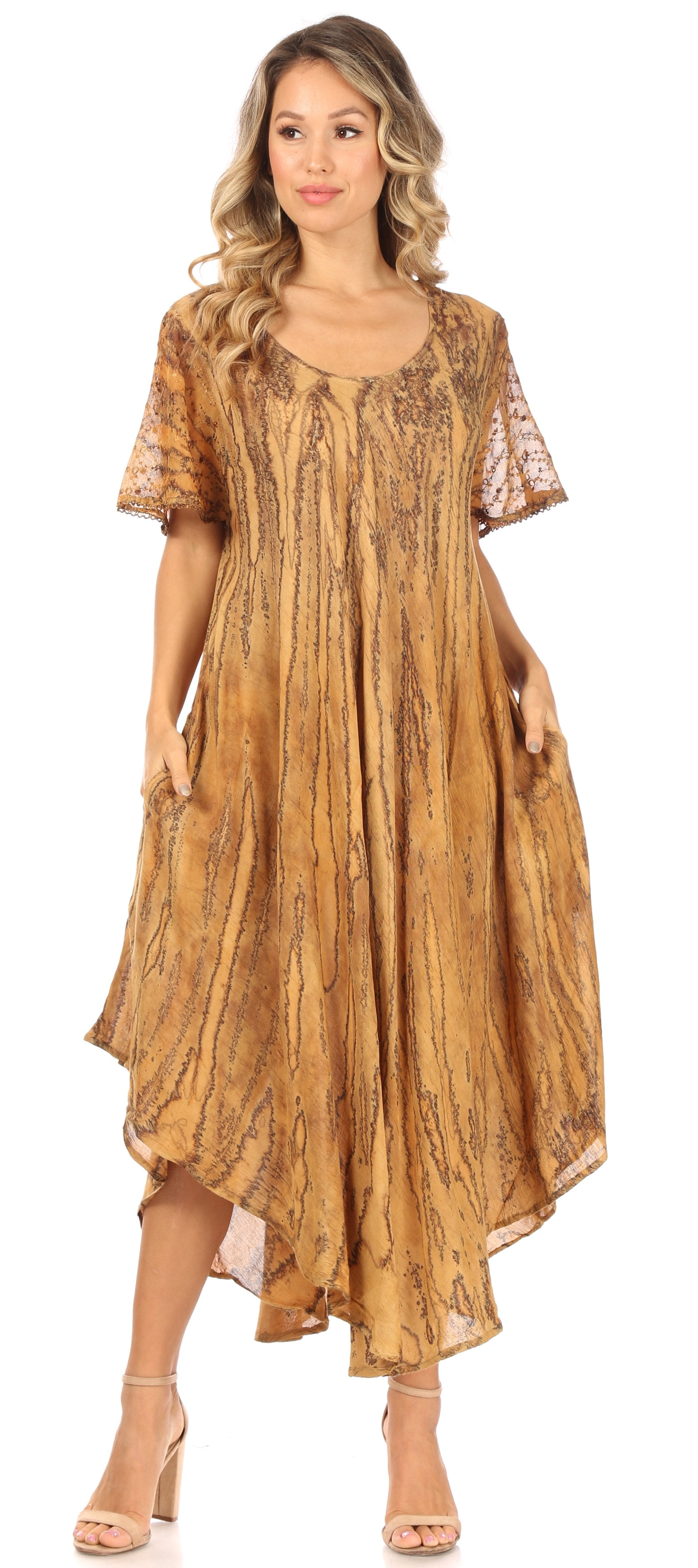 Woman wearing a long, patterned dress with lace sleeves on a white background