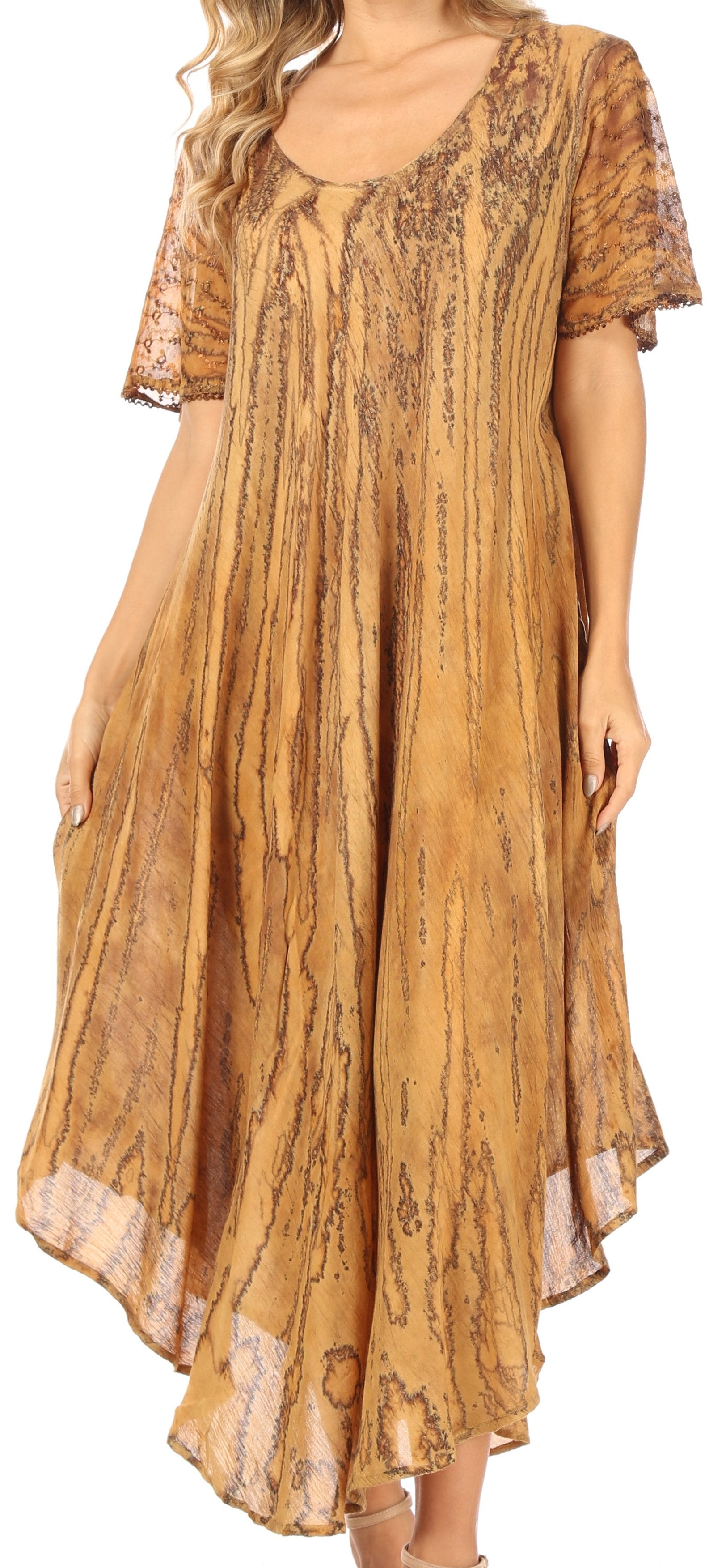 Woman wearing a long, patterned dress with short sleeves in a warm color.