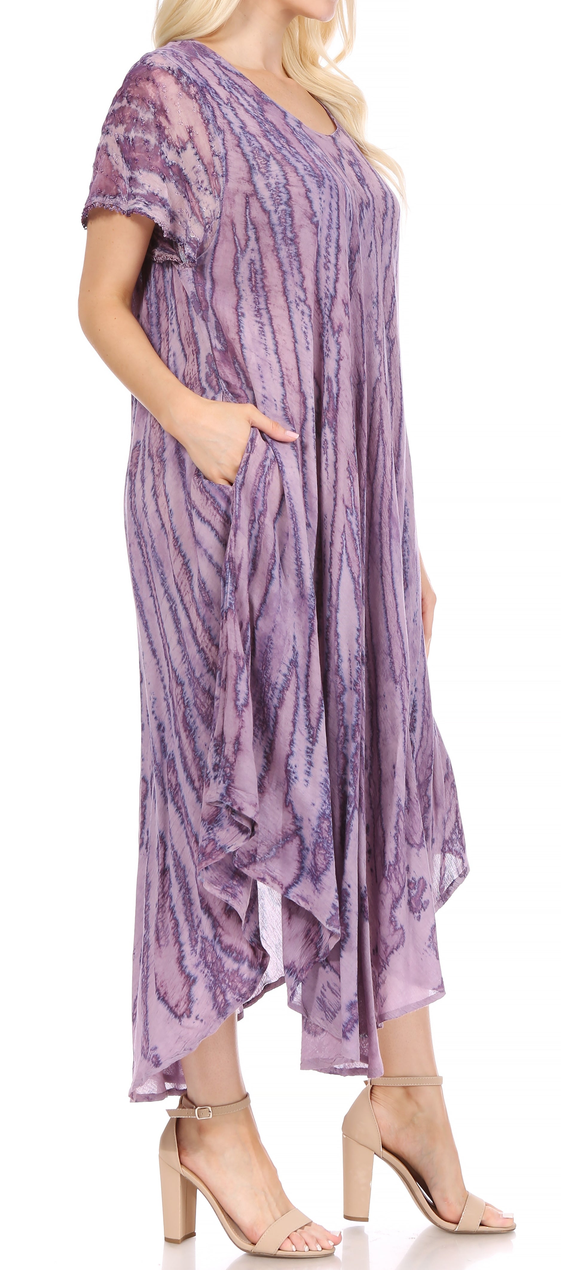 Woman wearing a purple patterned dress on a white background