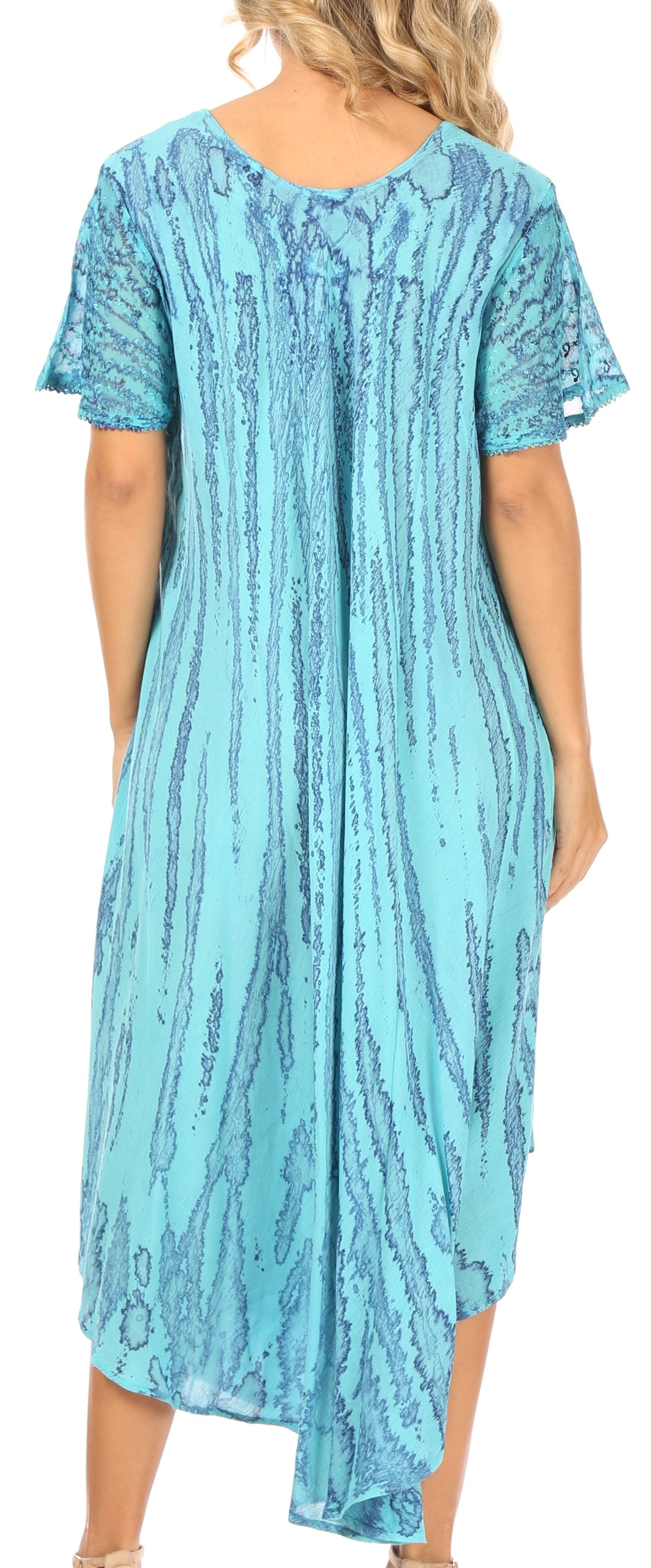 Woman wearing a blue patterned dress with short sleeves.
