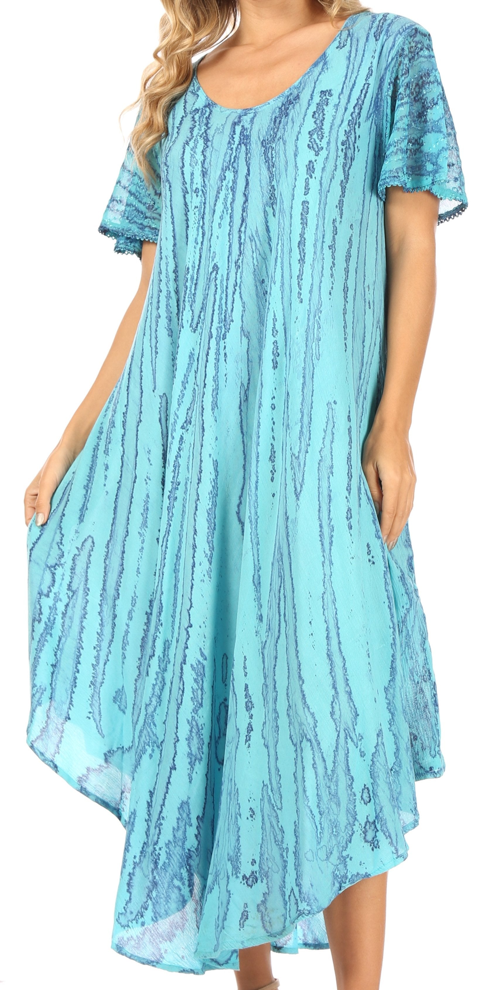 Woman wearing a blue patterned dress with short sleeves.