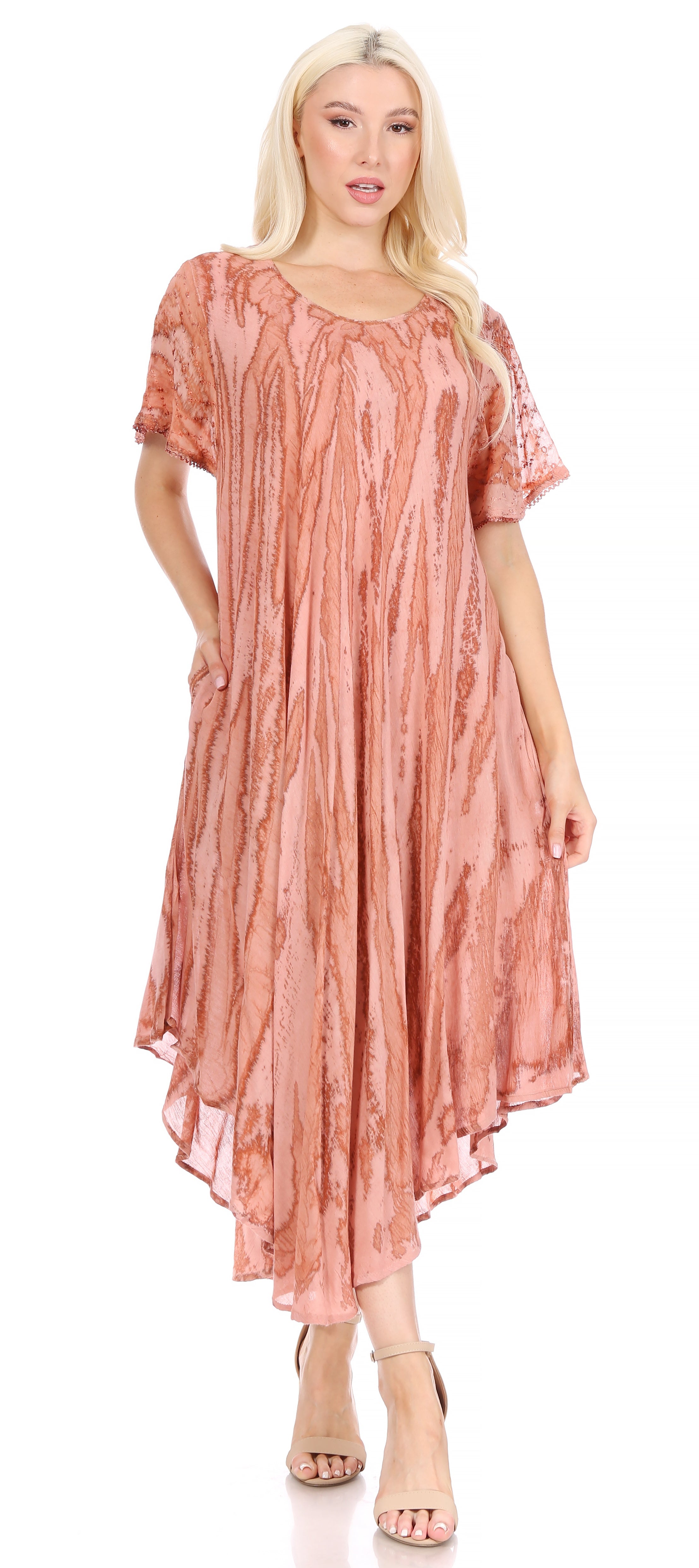 Woman wearing a pink patterned dress on a white background