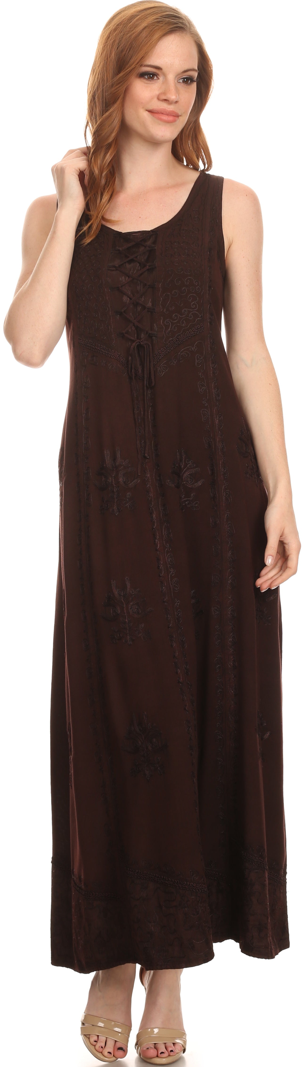 Woman wearing a brown sleeveless dress with a lace-up front on a white background
