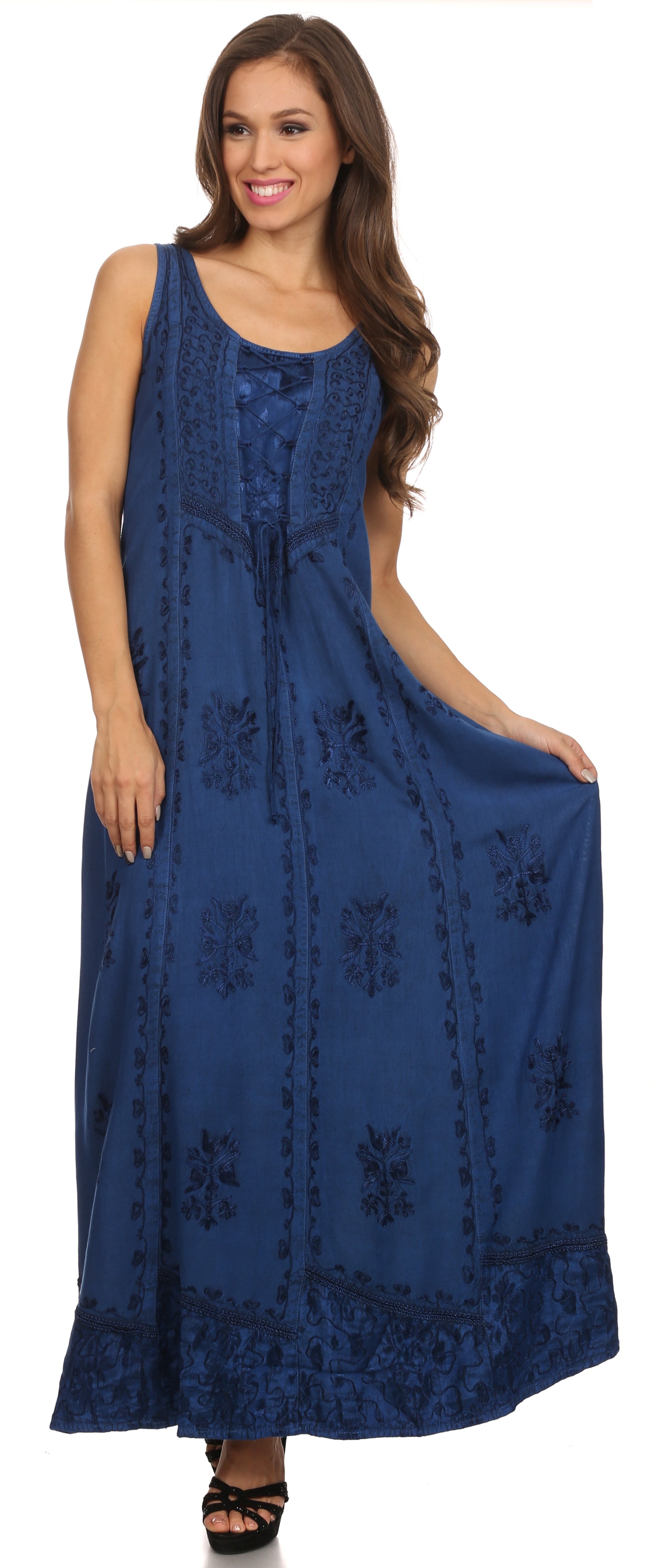 Woman wearing a blue sleeveless dress with floral patterns on a white background