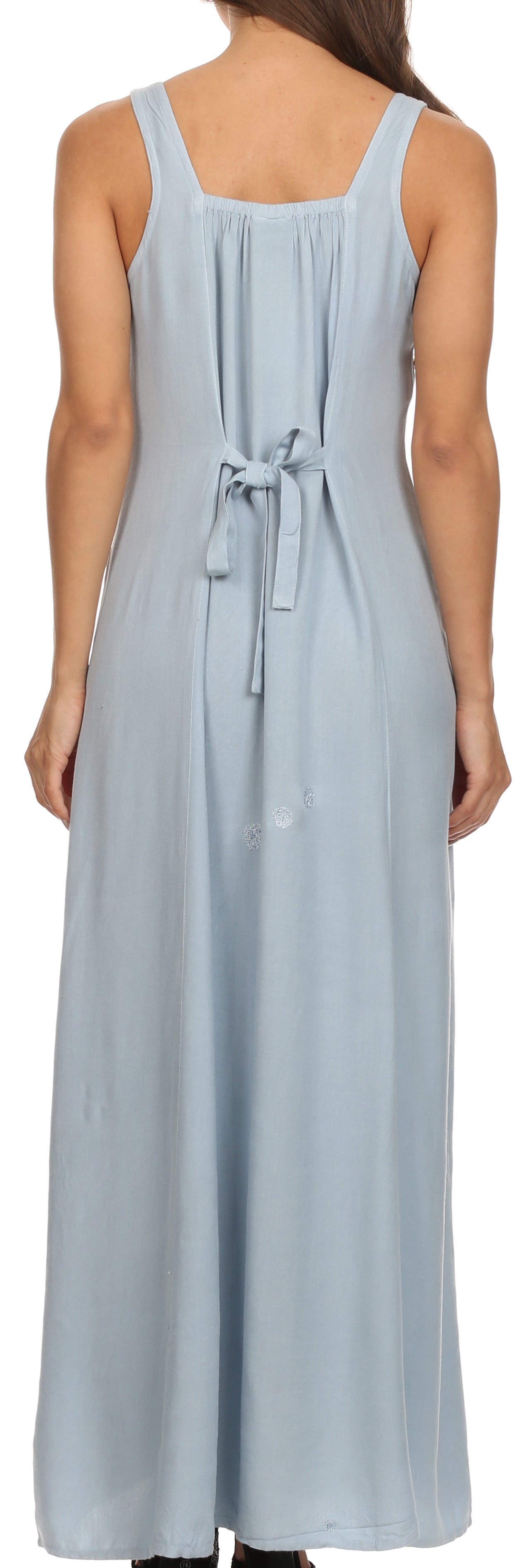 Woman wearing a light blue sleeveless dress with a tie waist.