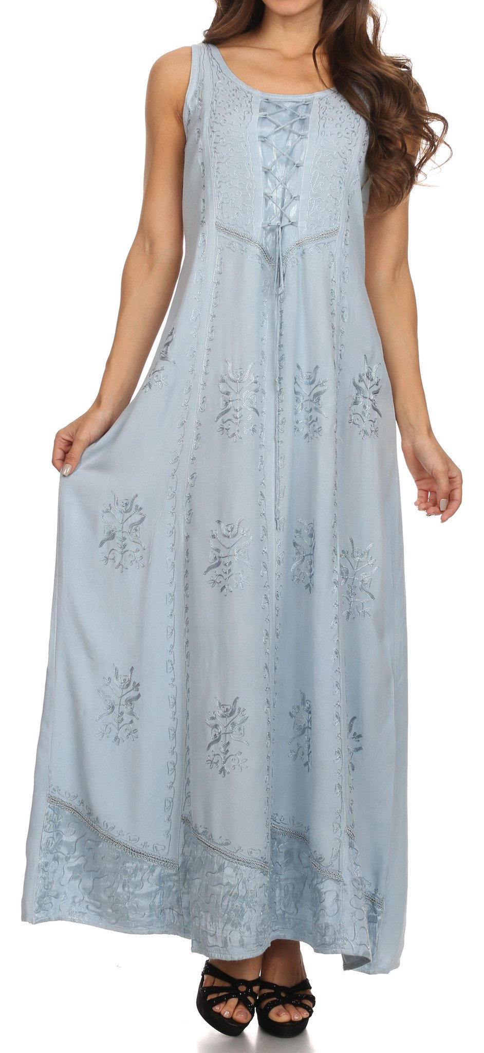 Woman wearing a light blue sleeveless dress with floral embroidery on a white background