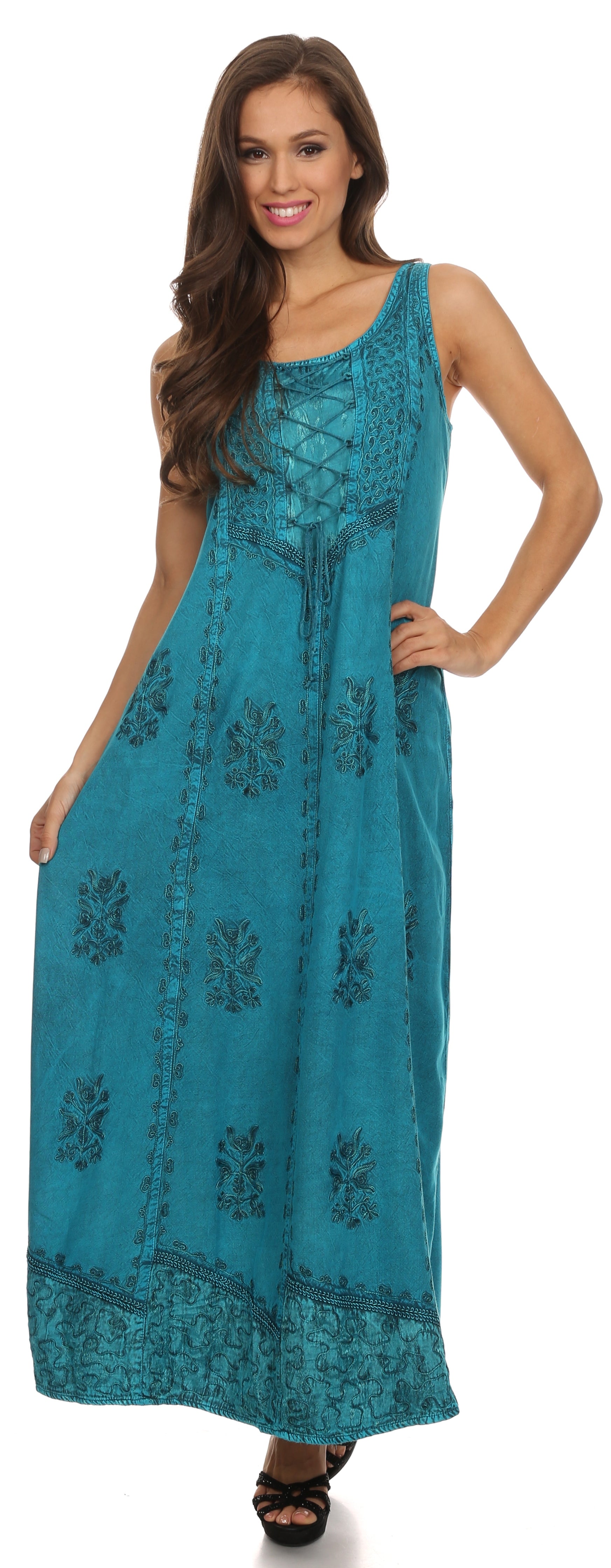 Woman wearing a teal dress with floral patterns on a white background