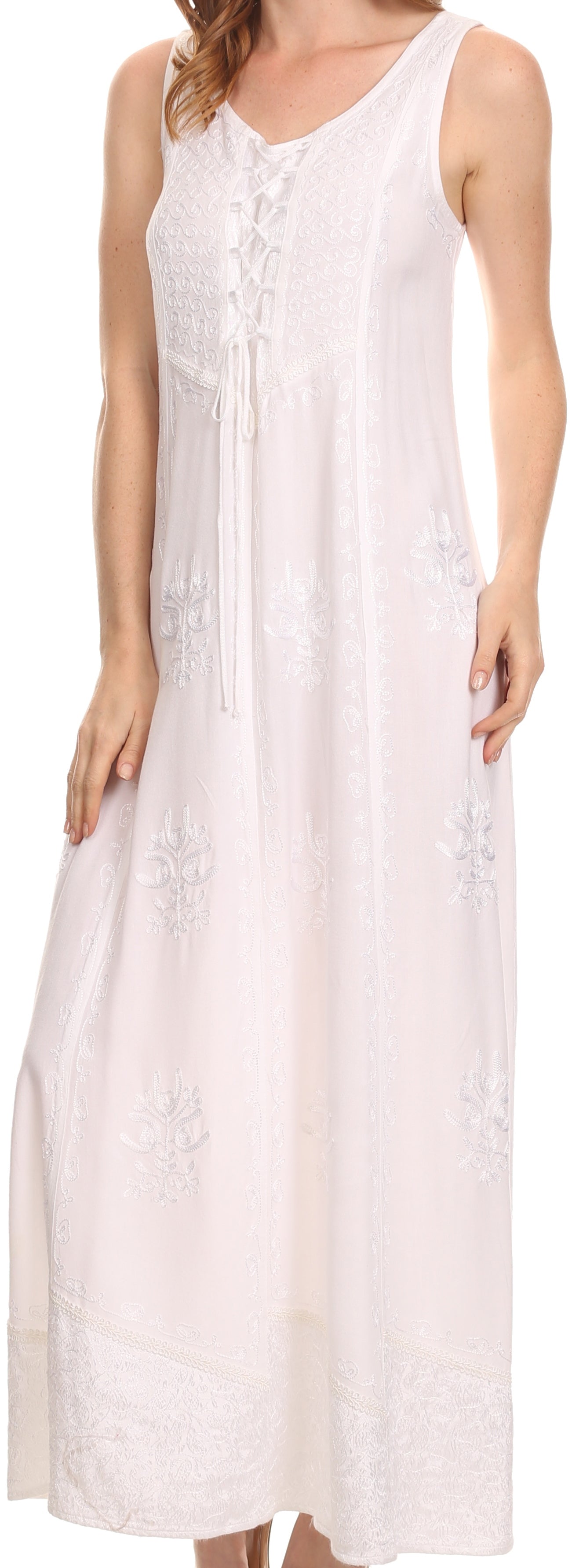 Woman wearing a white sleeveless dress with lace details.