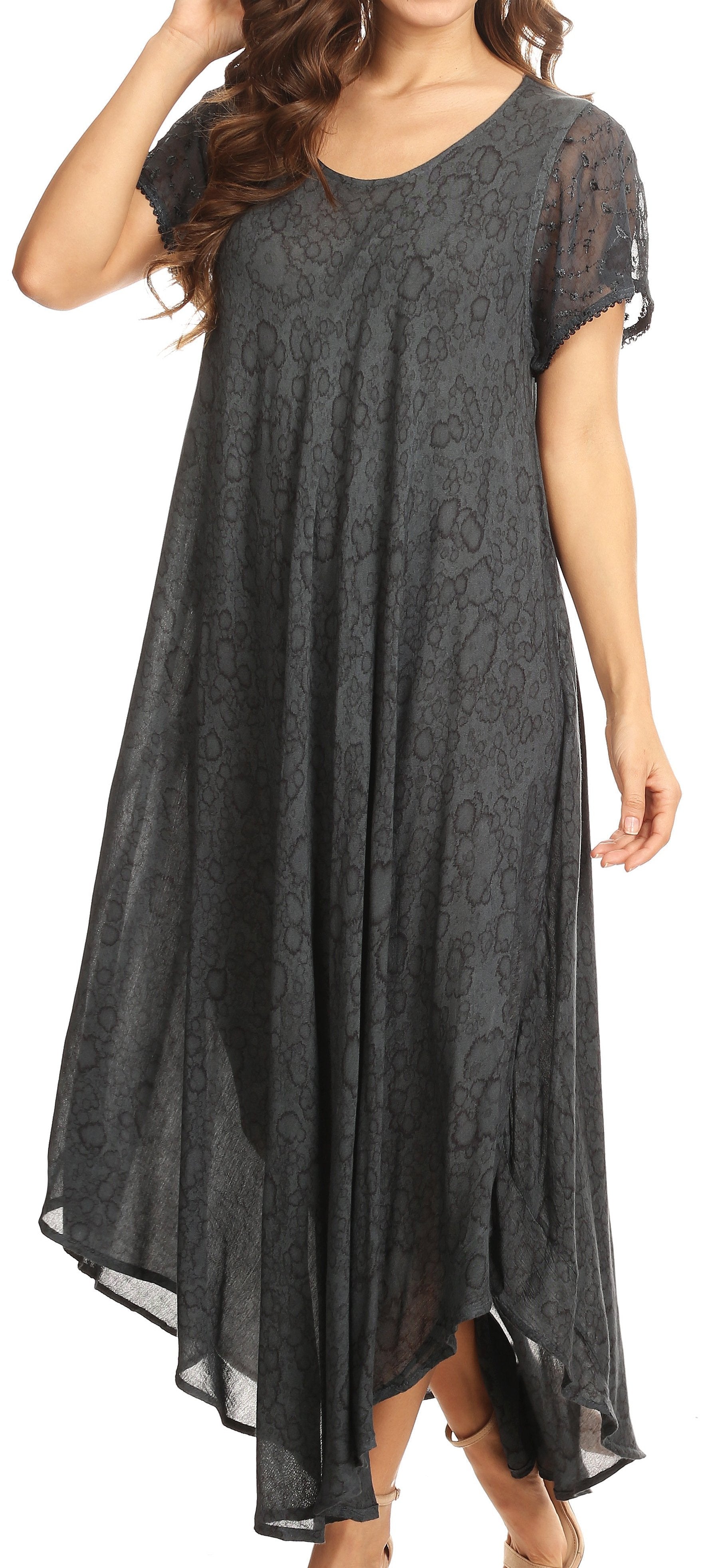 Woman wearing a long, dark gray dress with lace details.