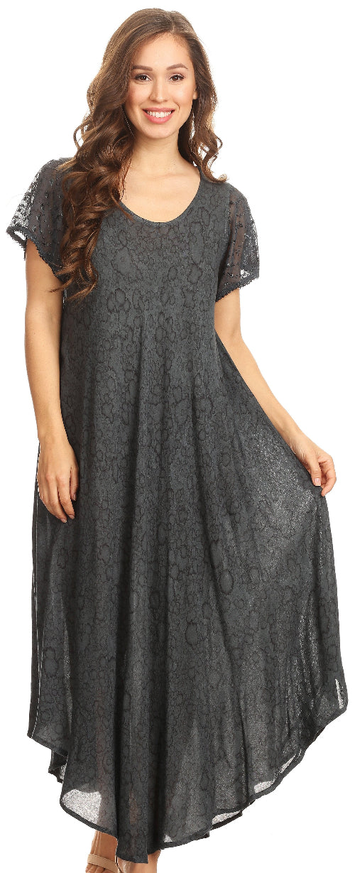 Woman wearing a long dark gray dress with lace details on a white background