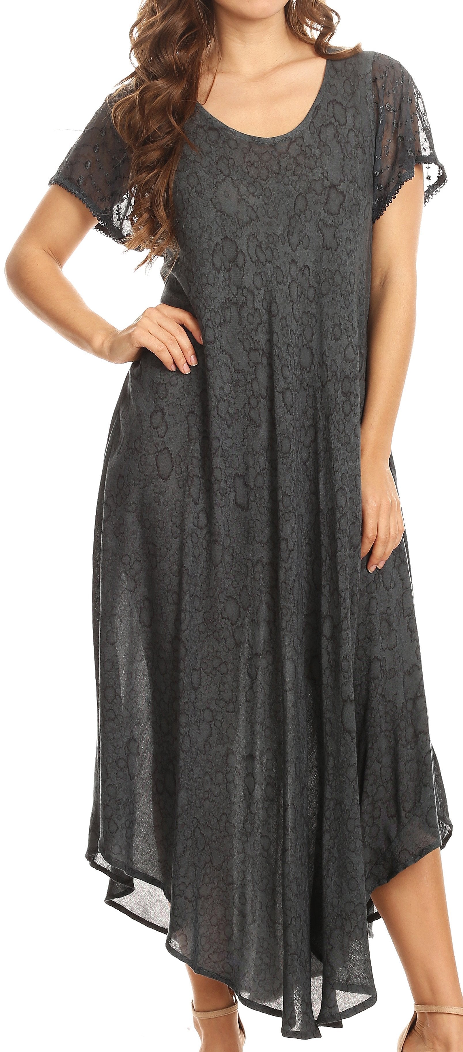 Woman wearing a dark gray lace dress with sheer sleeves on a white background