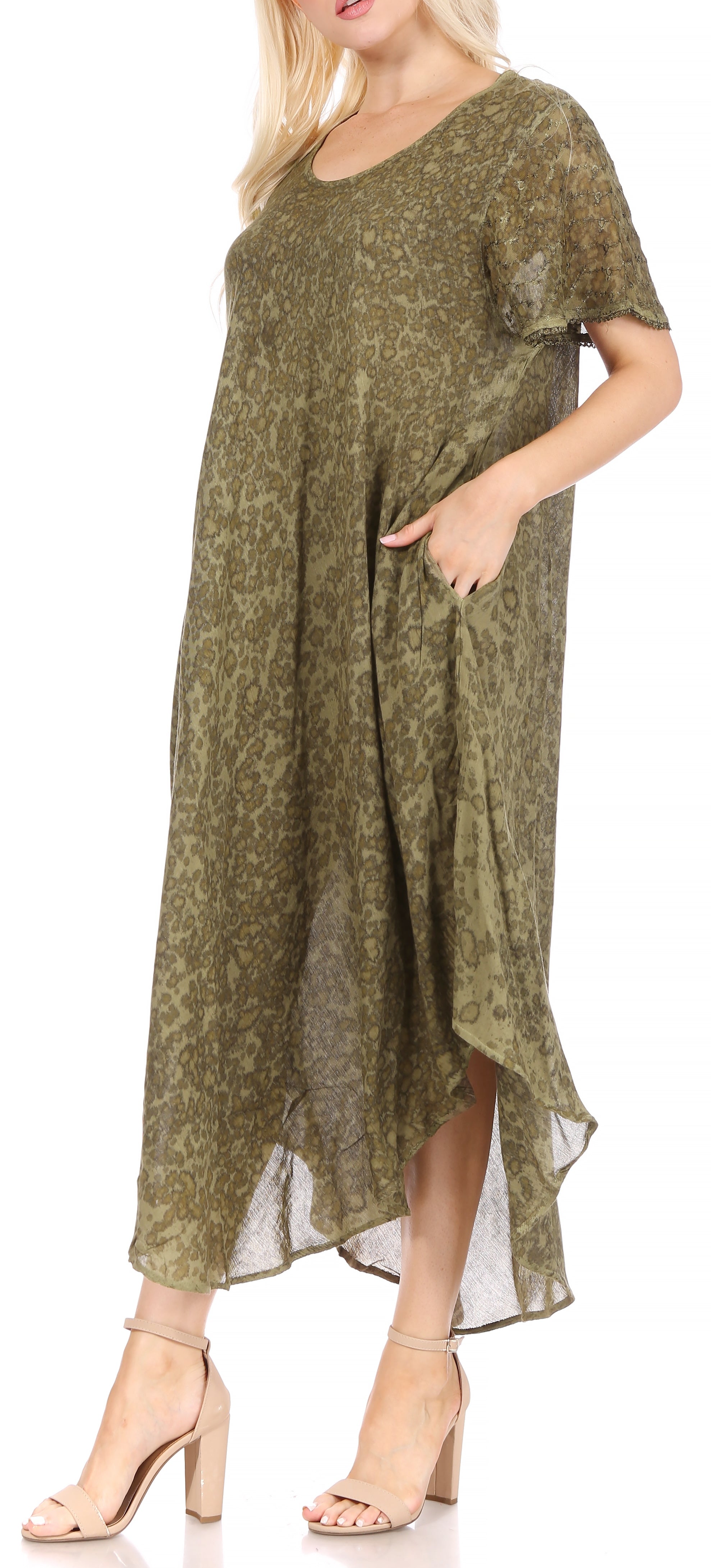 Woman wearing a green patterned dress on a white background