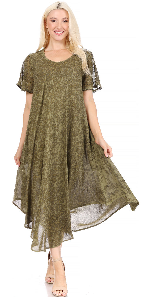 Woman wearing a green dress with sheer sleeves on a white background