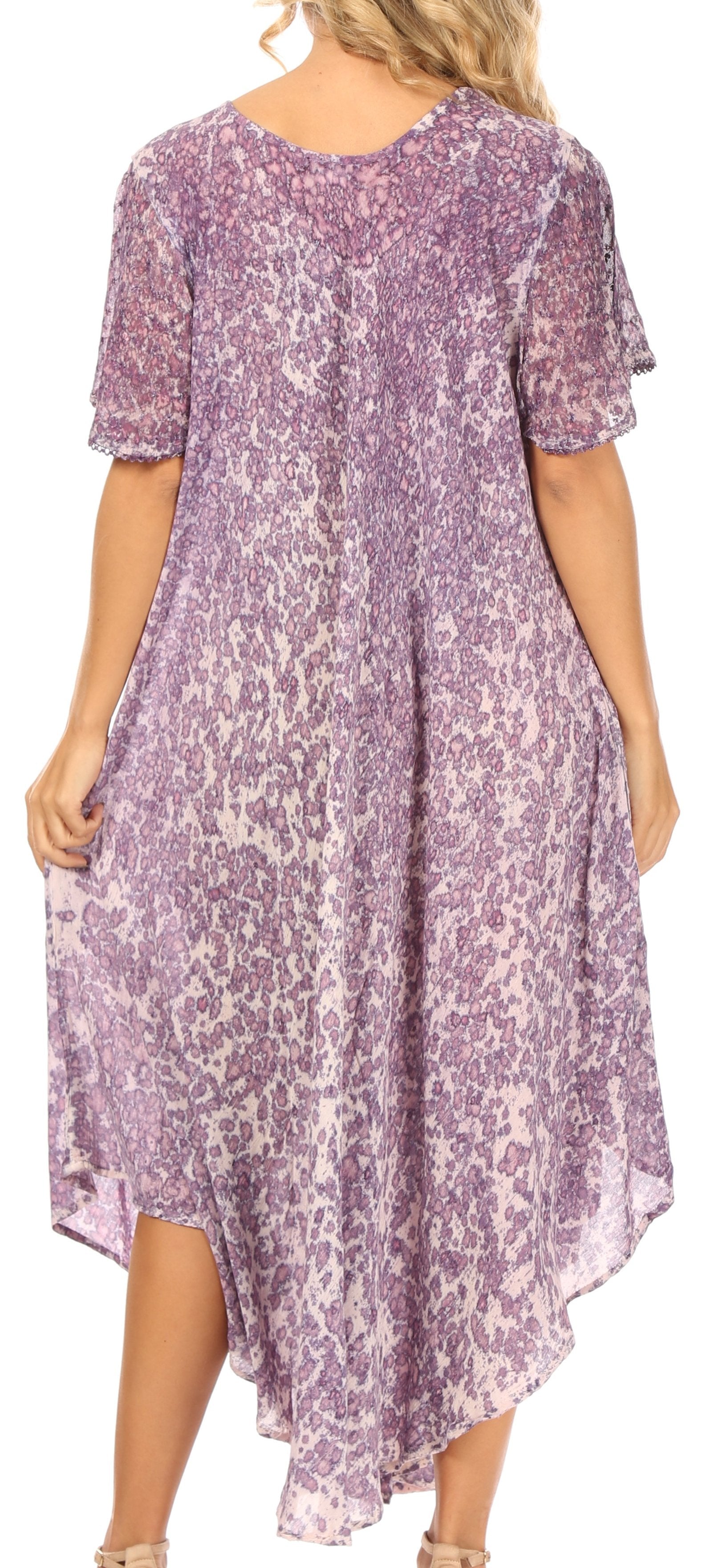 Woman wearing a purple floral dress with a flowing design.