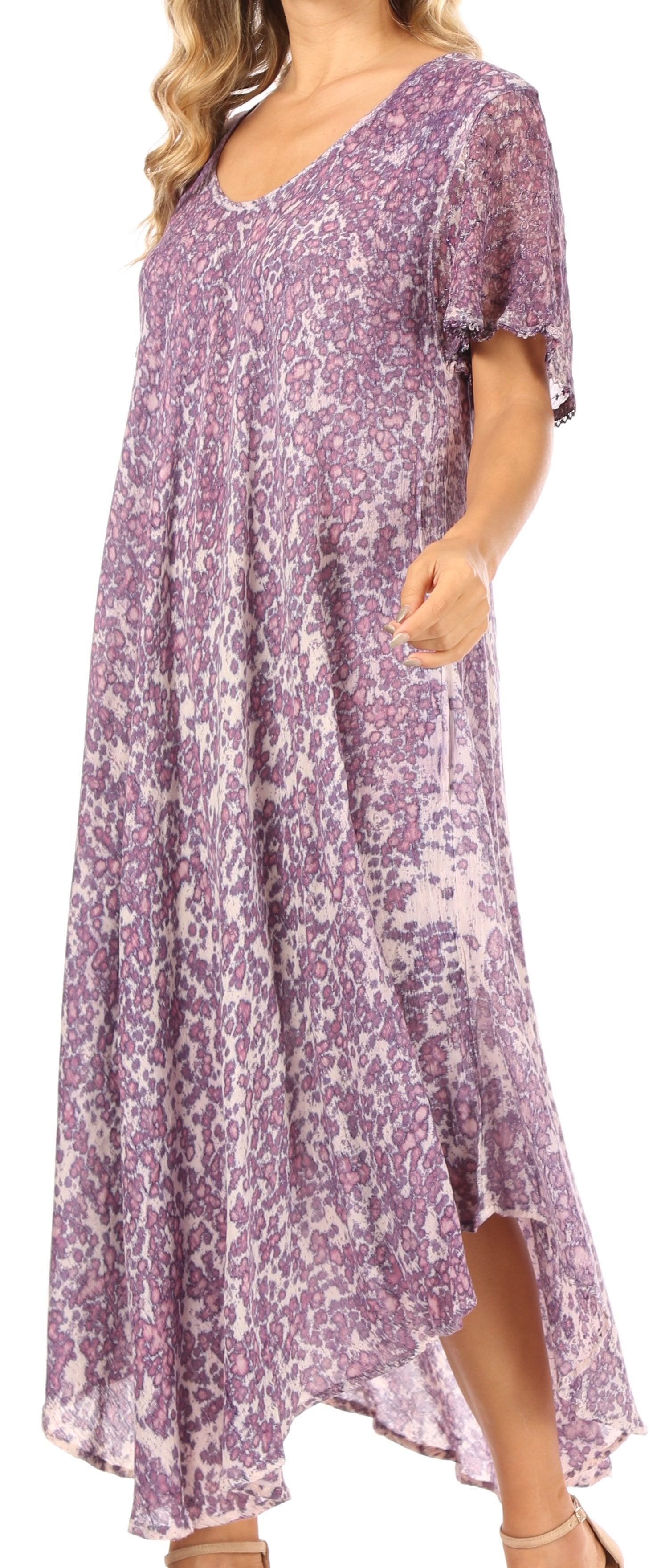 Woman wearing a purple floral dress against a white background